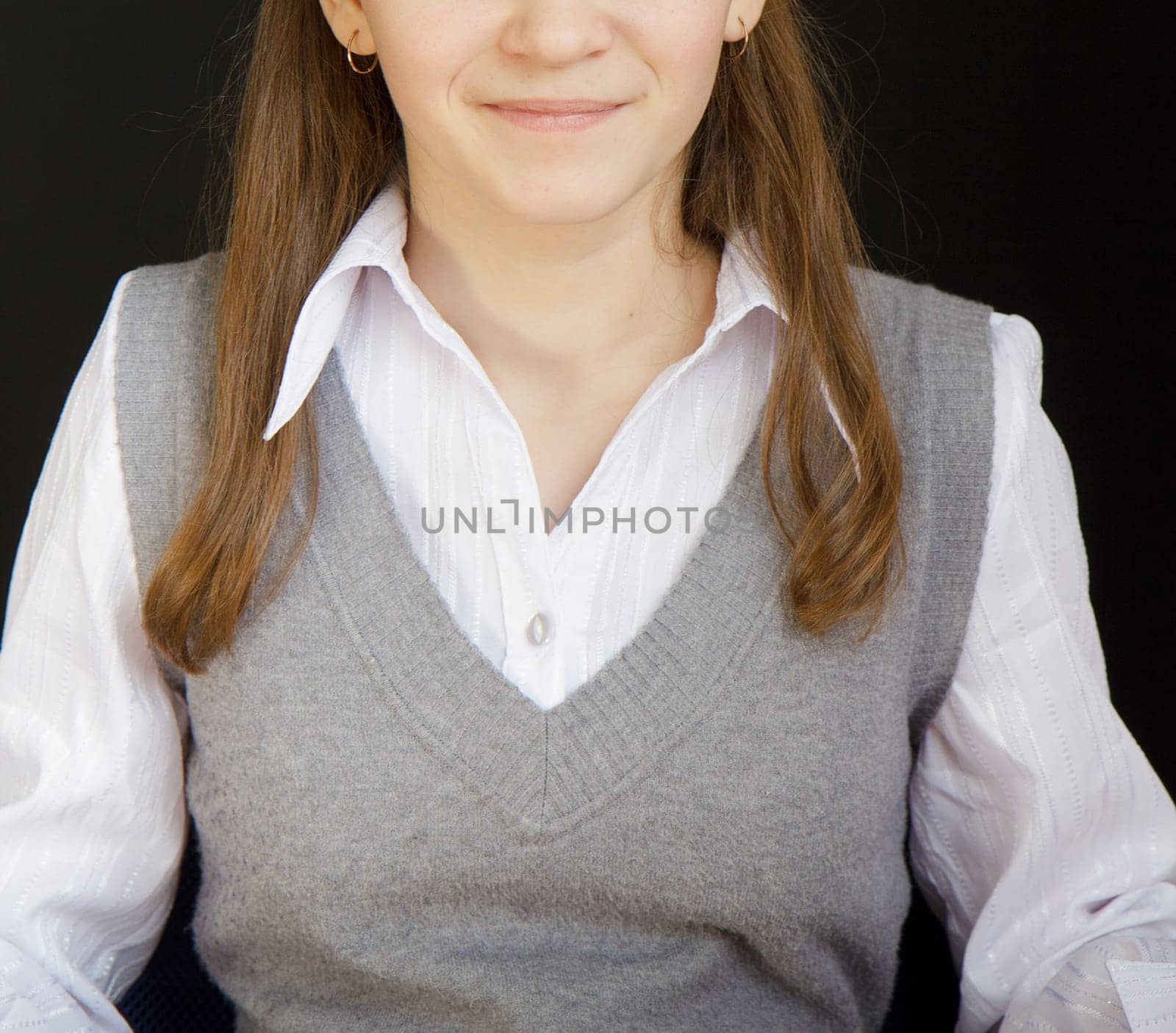 portrait of a girl with a white blouse and a gray vest