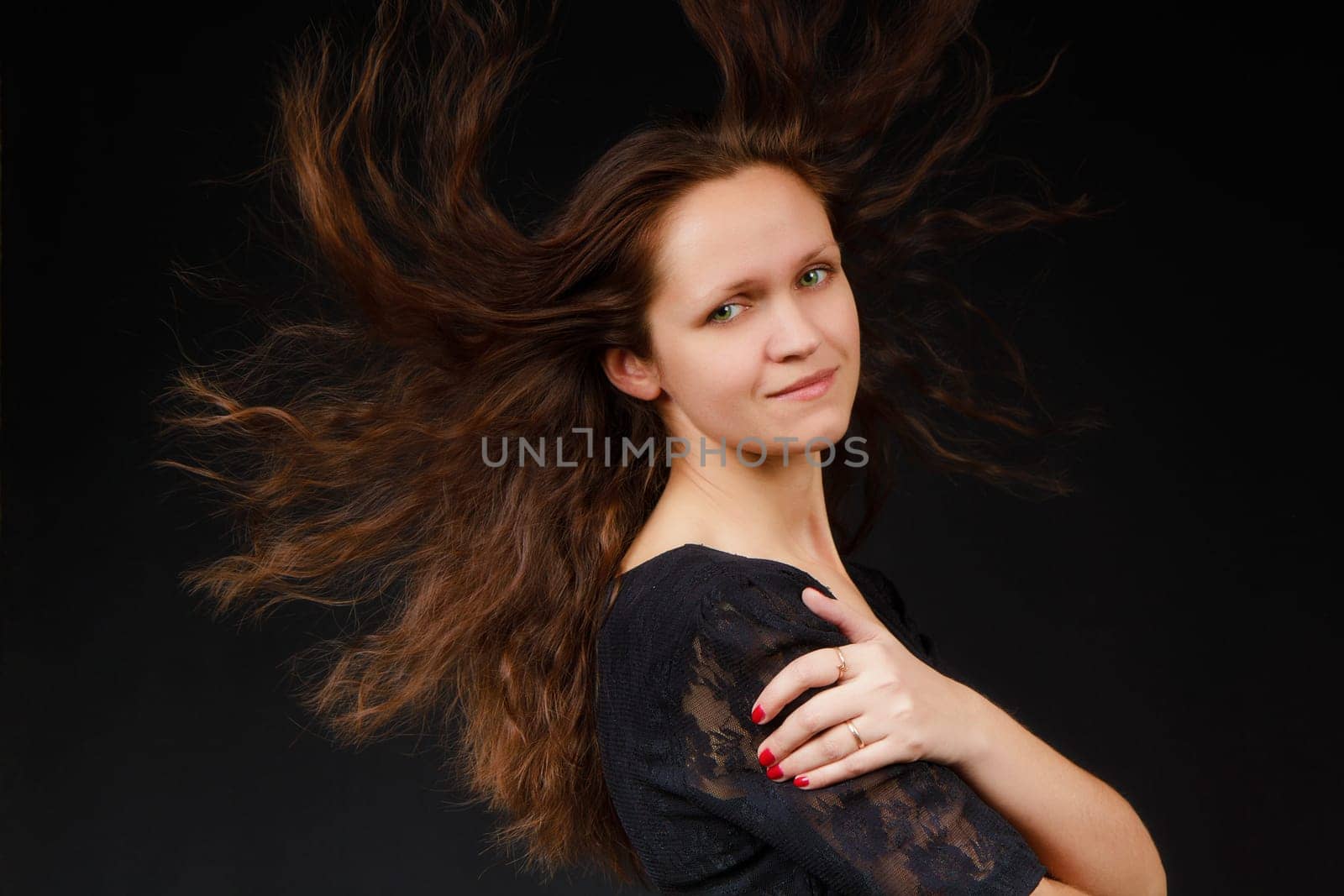 sexy girl with flowing long hair on a black background