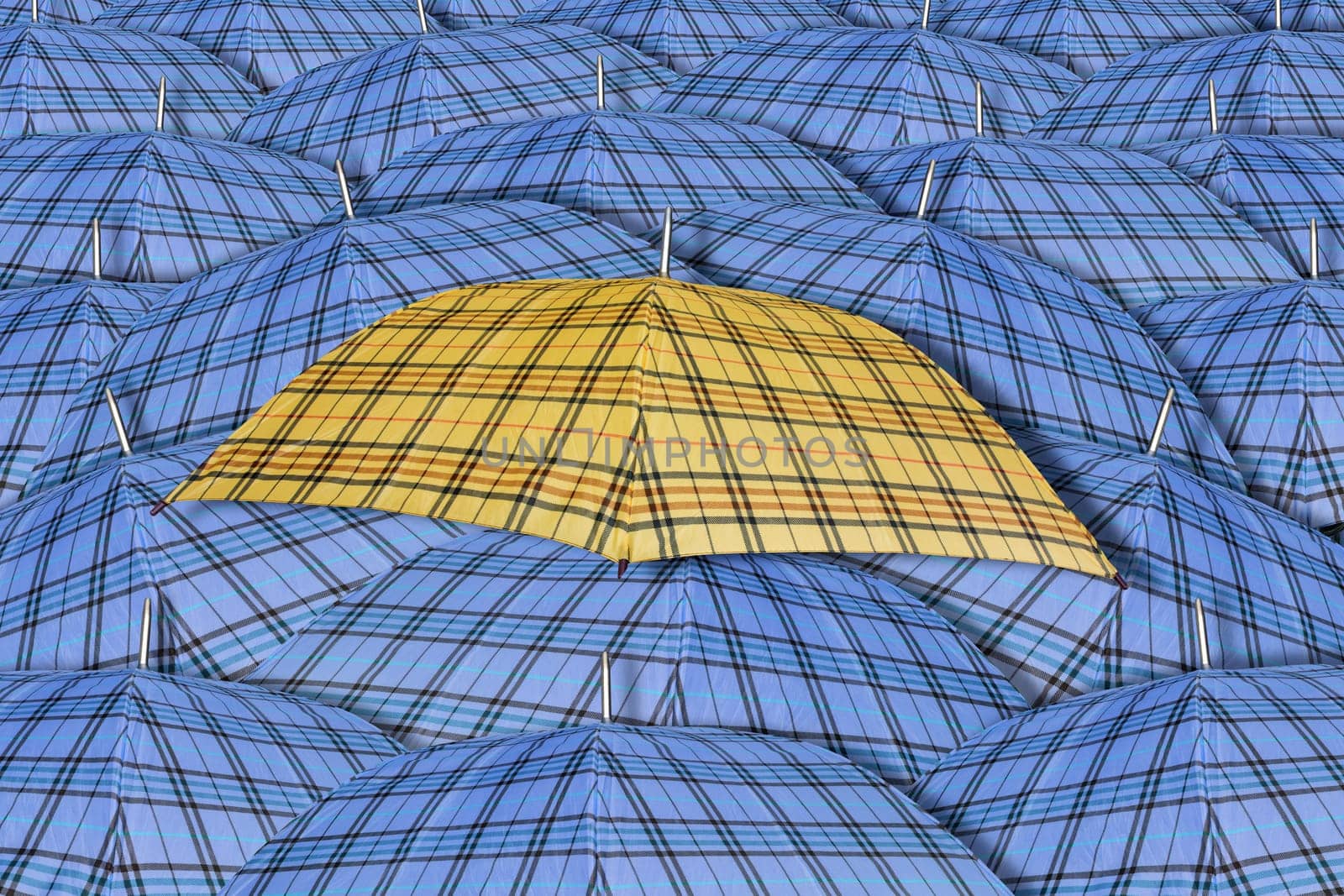Yellow umbrella standing out from background of blue umbrellas