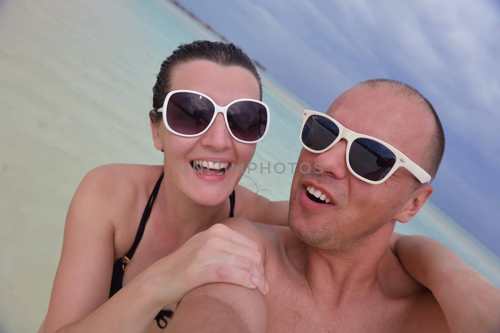 happy young couple relax and take fresh drink at summer vacation