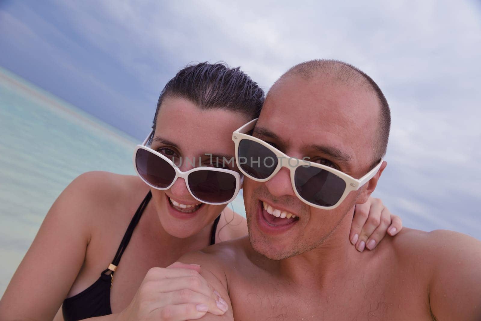 happy young couple relax and take fresh drink at summer vacation