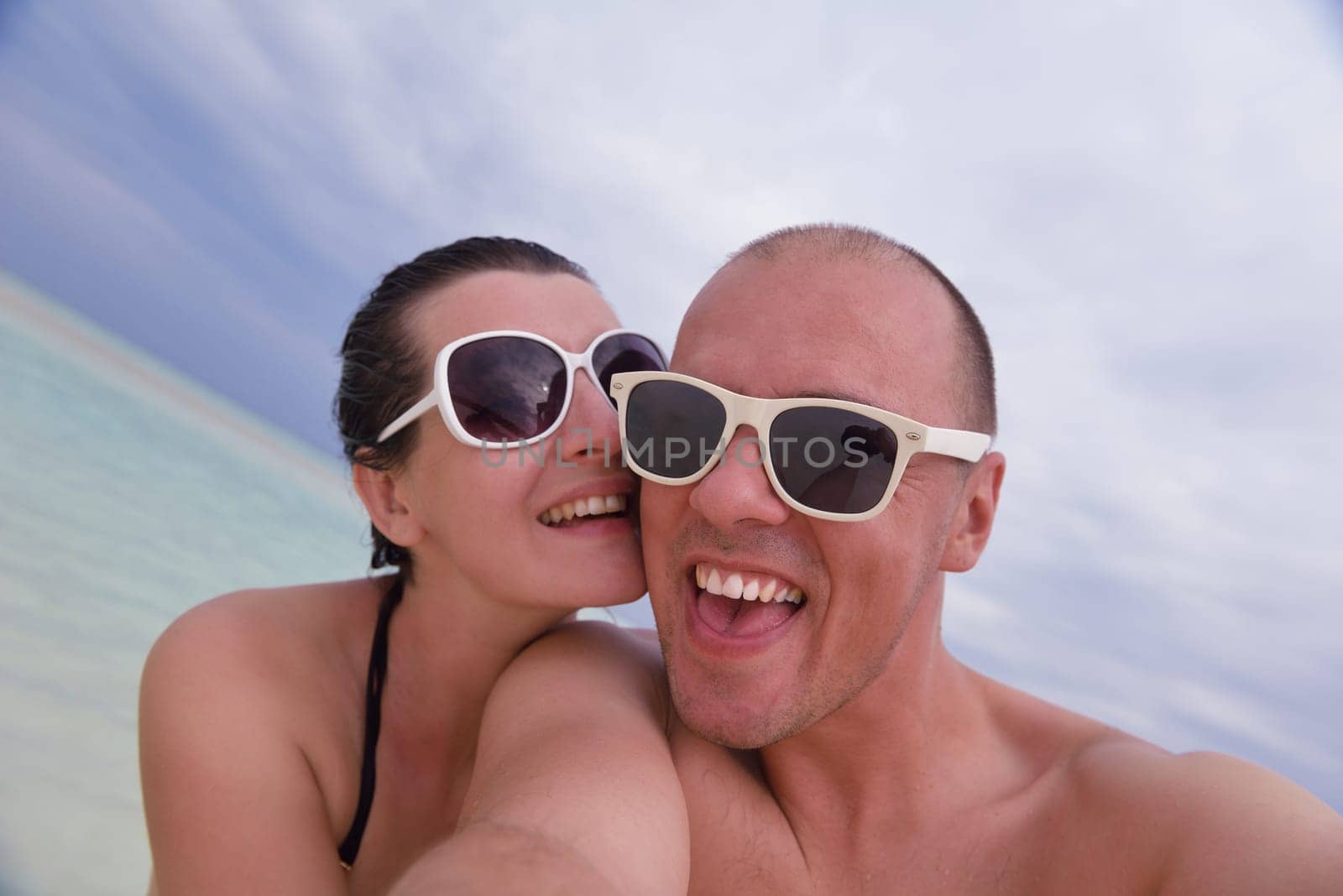 happy young couple relax and take fresh drink at summer vacation