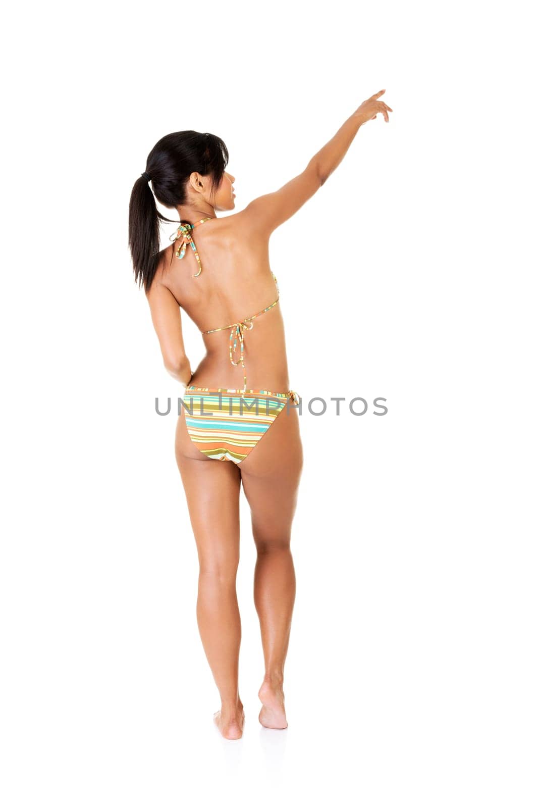 happy excited tanned summer woman pointing on copy space. isolated on white.