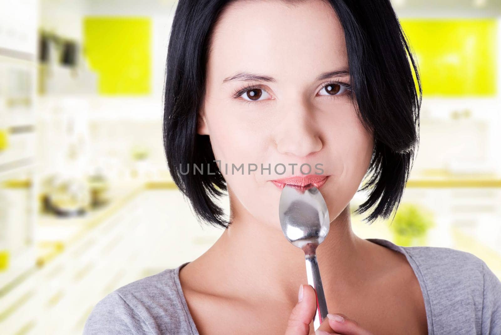 young smiling woman with spoon (pleasure from eating)