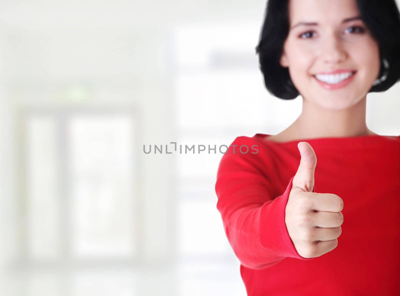 beautiful young woman showing thumbs up sign