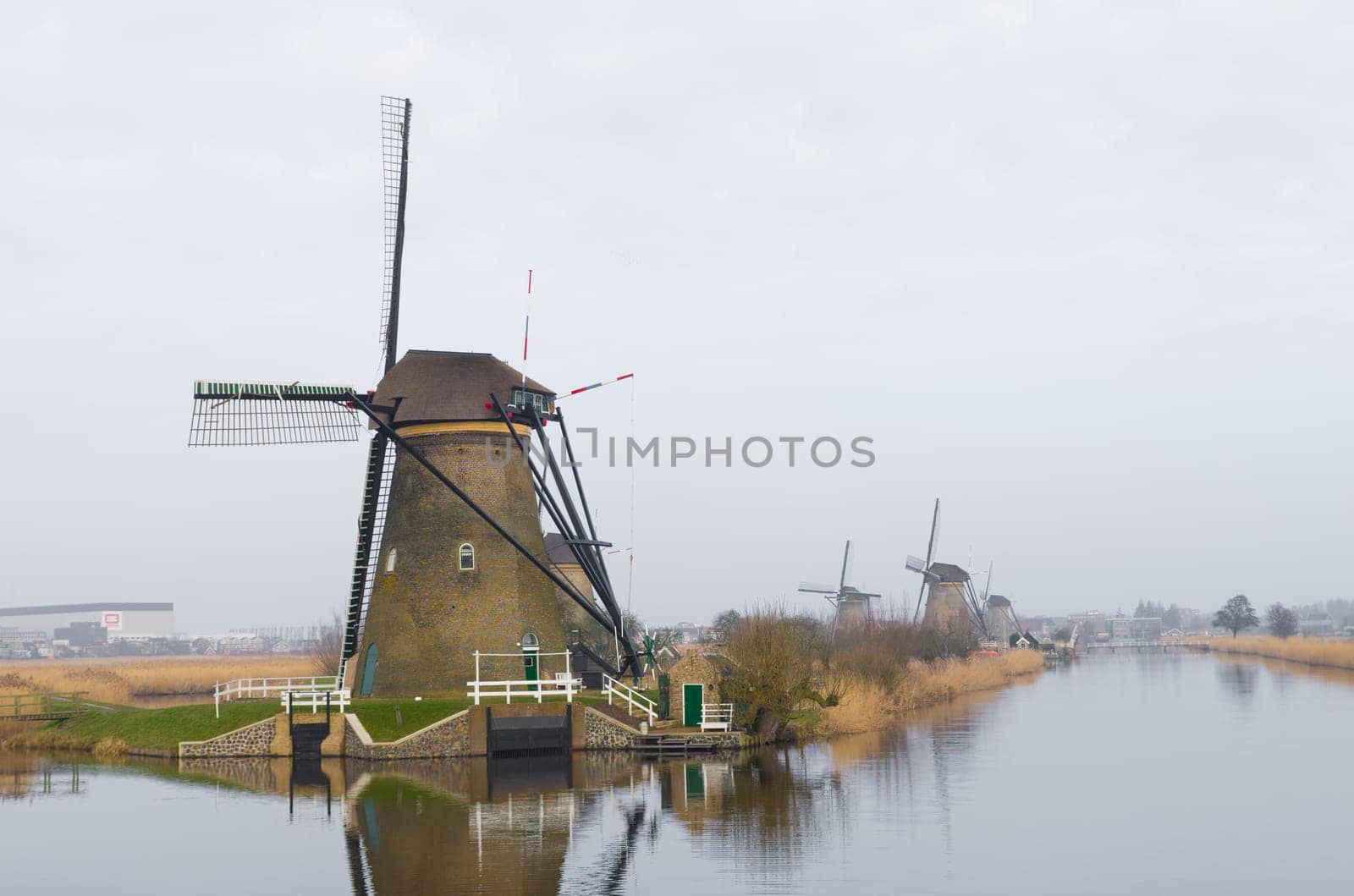 typical dutch windmills at Kinderdijk, Netherlands. A system of 19 windmills was built around 1740 to drain the polder. This group of mills is the largest concentration of old windmills in the Netherlands. The windmills of Kinderdijk are one of the best known Dutch tourist sites. They have been a UNESCO World Heritage Site since 1997.