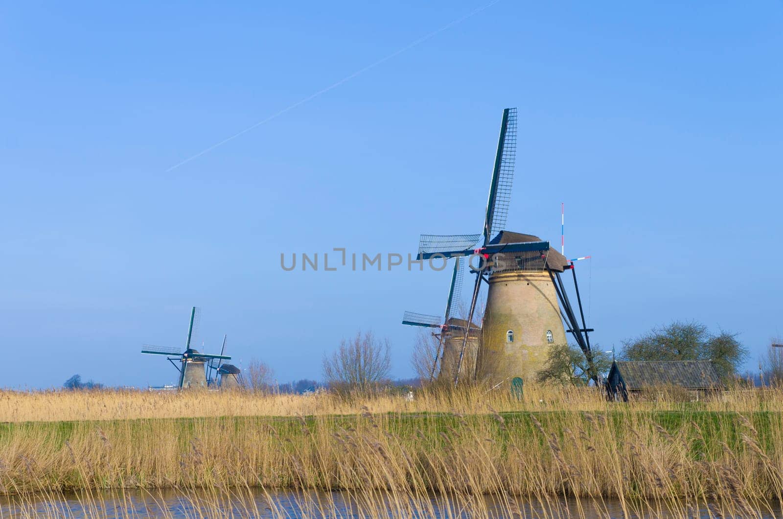 Dutch windmills in Kinderdijk, Netherlands. The windmills of Kinderdijk are one of the best known Dutch tourist sites. They have been a UNESCO World Heritage Site since 1997.