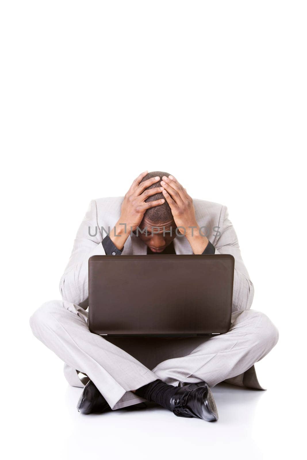 Stressed businessman working on laptop, isolated on white
