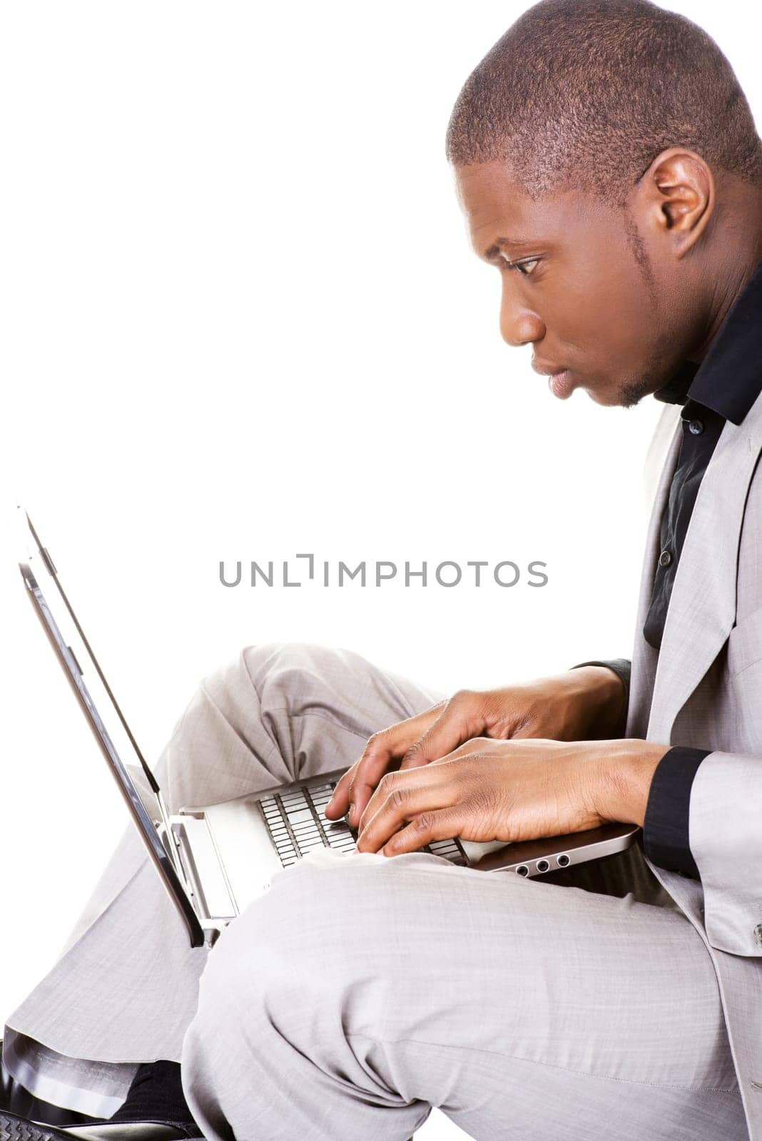 Successful businessman working on laptop, isolated on white