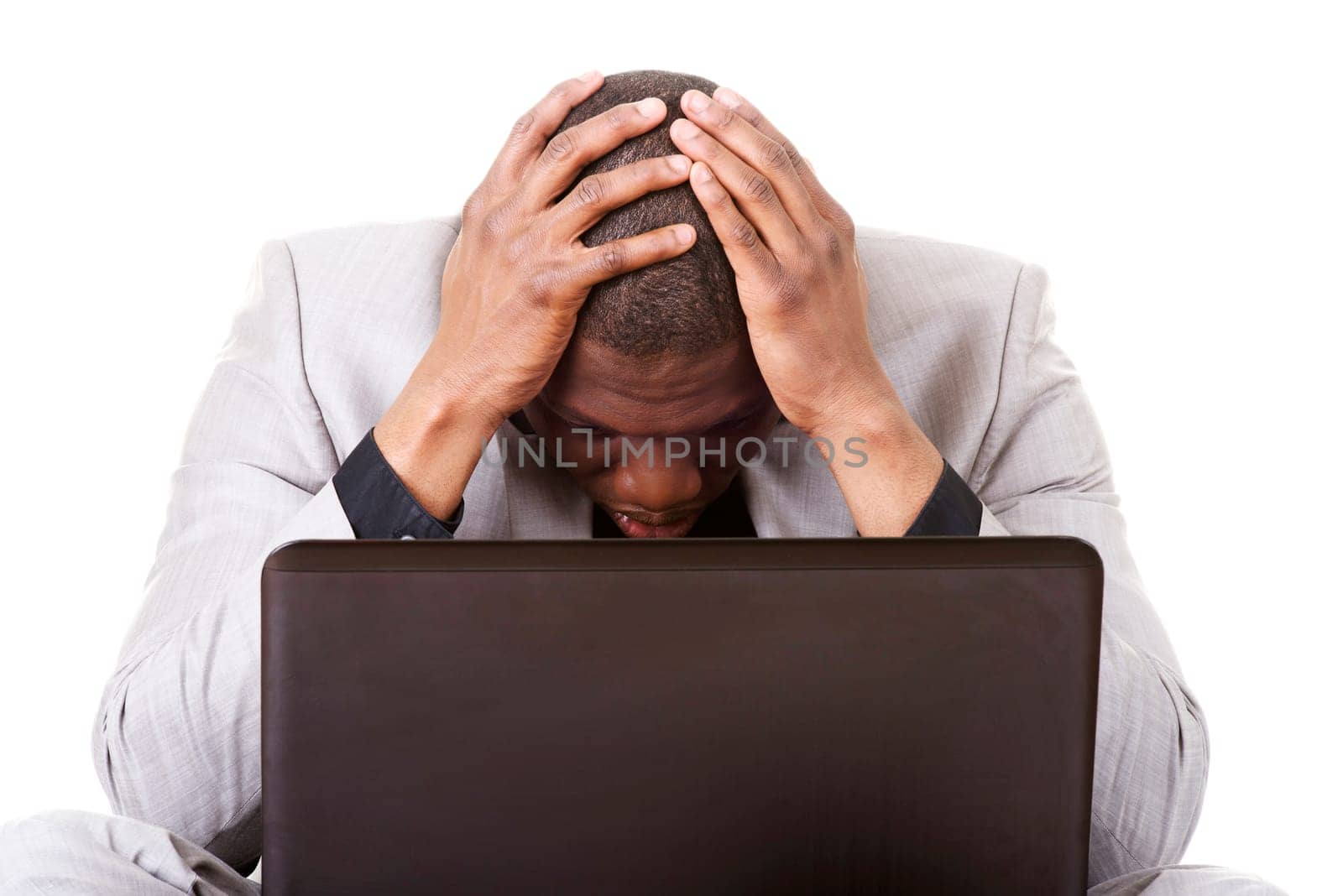 Stressed businessman working on laptop, isolated on white