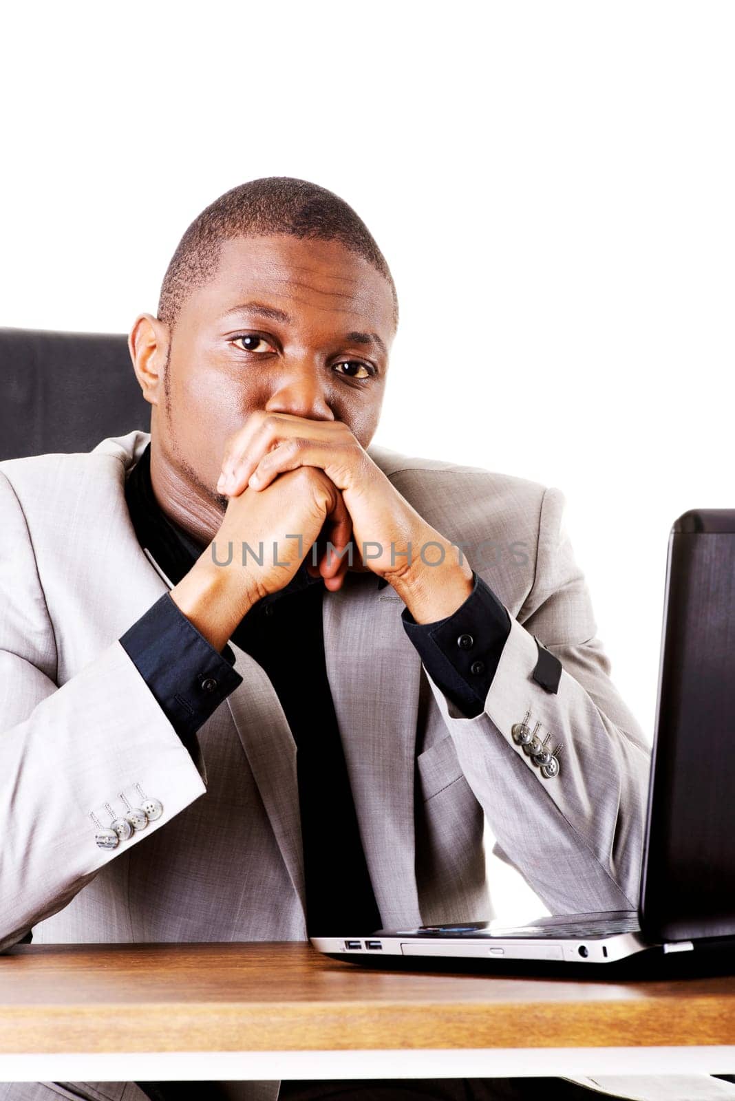 Stressed businessman working on laptop, isolated on white