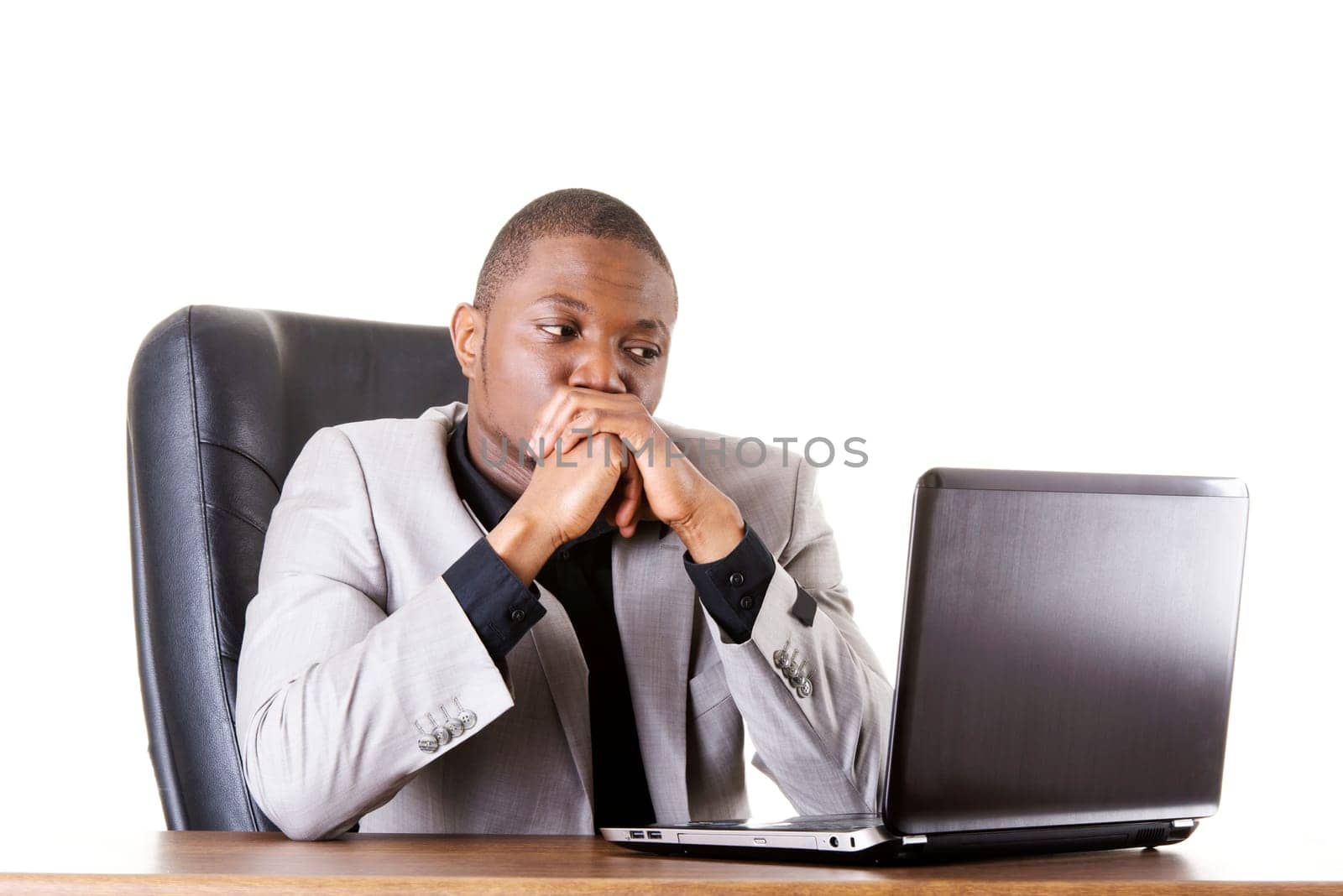 Stressed businessman working on laptop, isolated on white