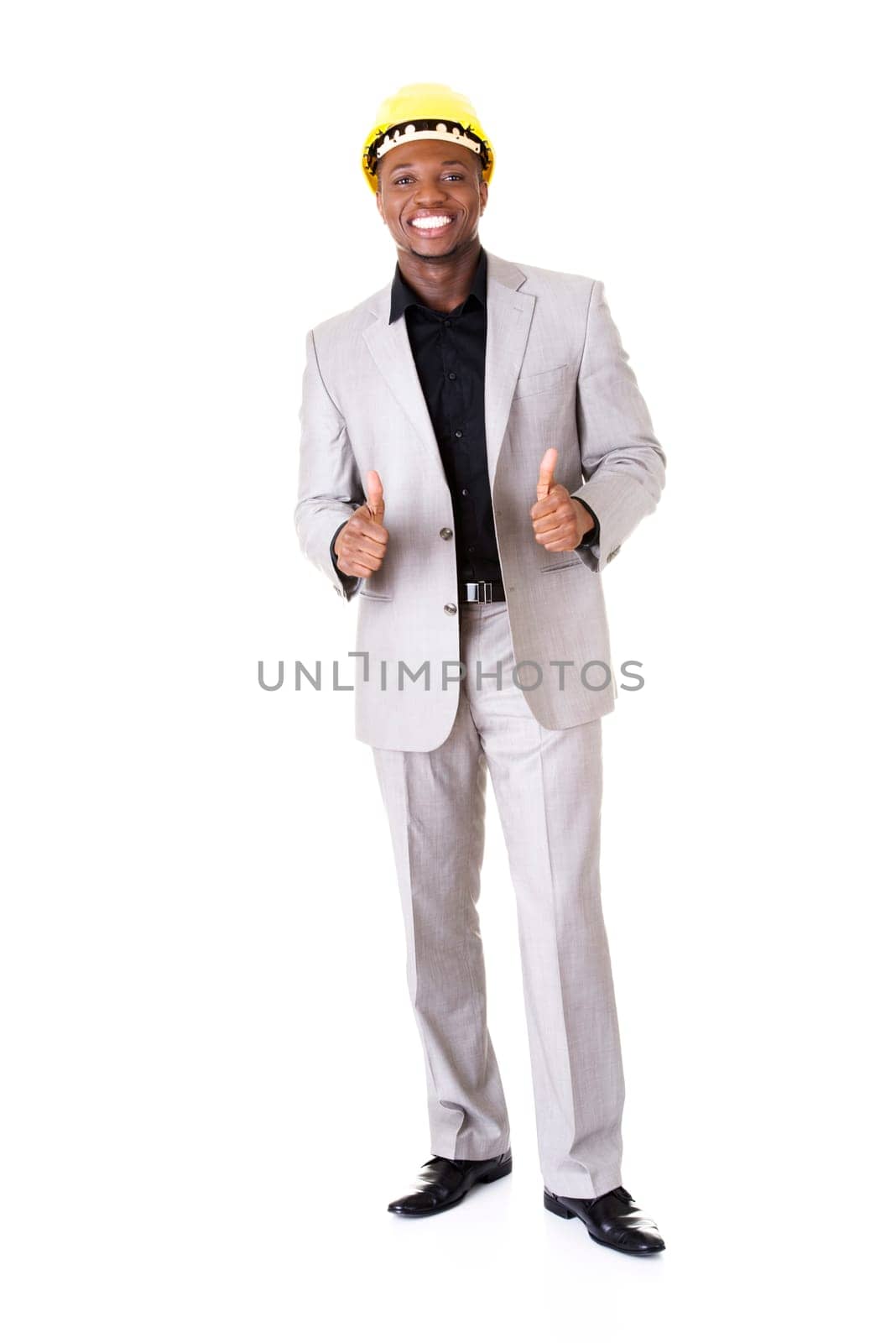 Happy successful businesman in helmet gesturinh thumbs up. Isolated on white.