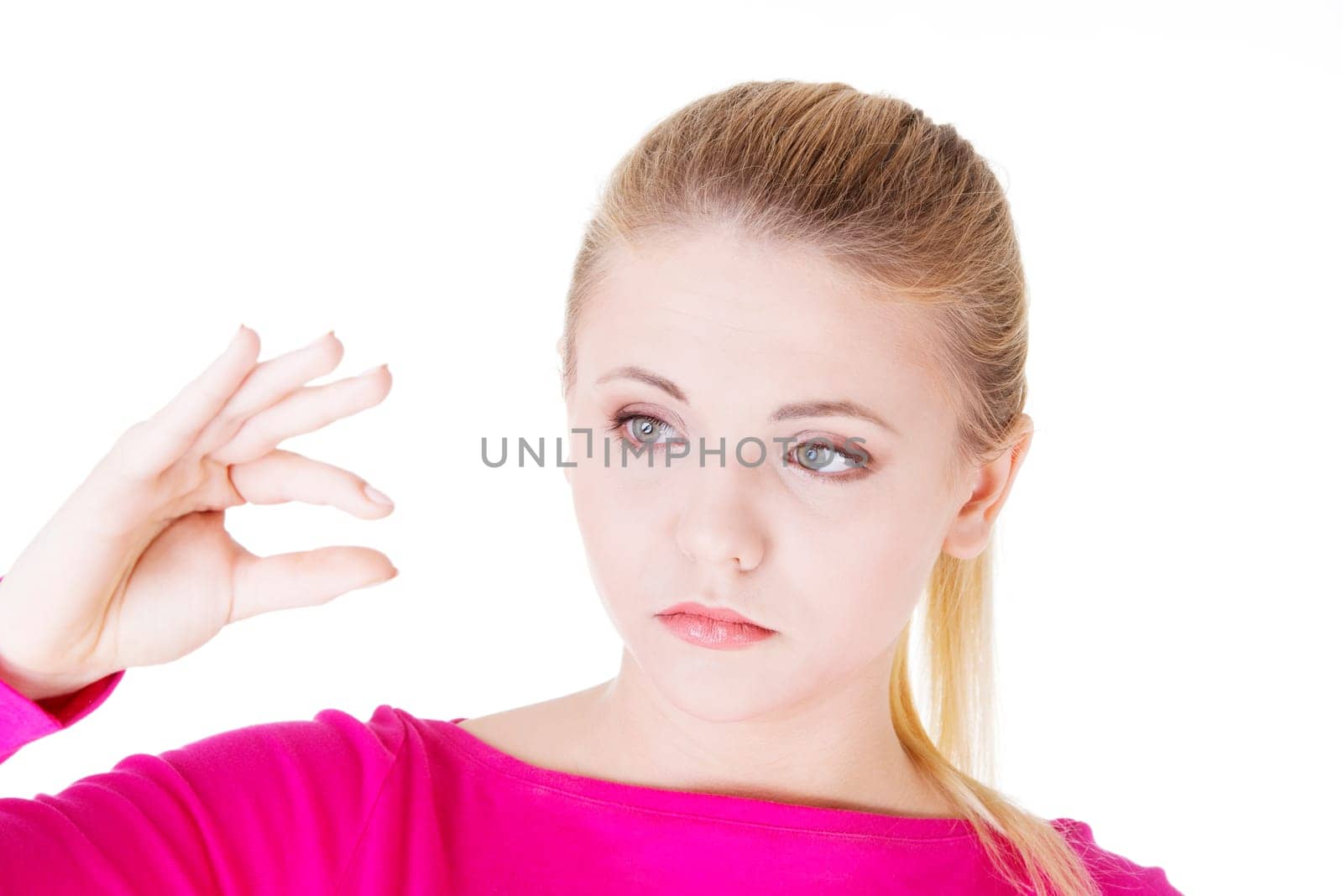Woman showing something small, isolated on white