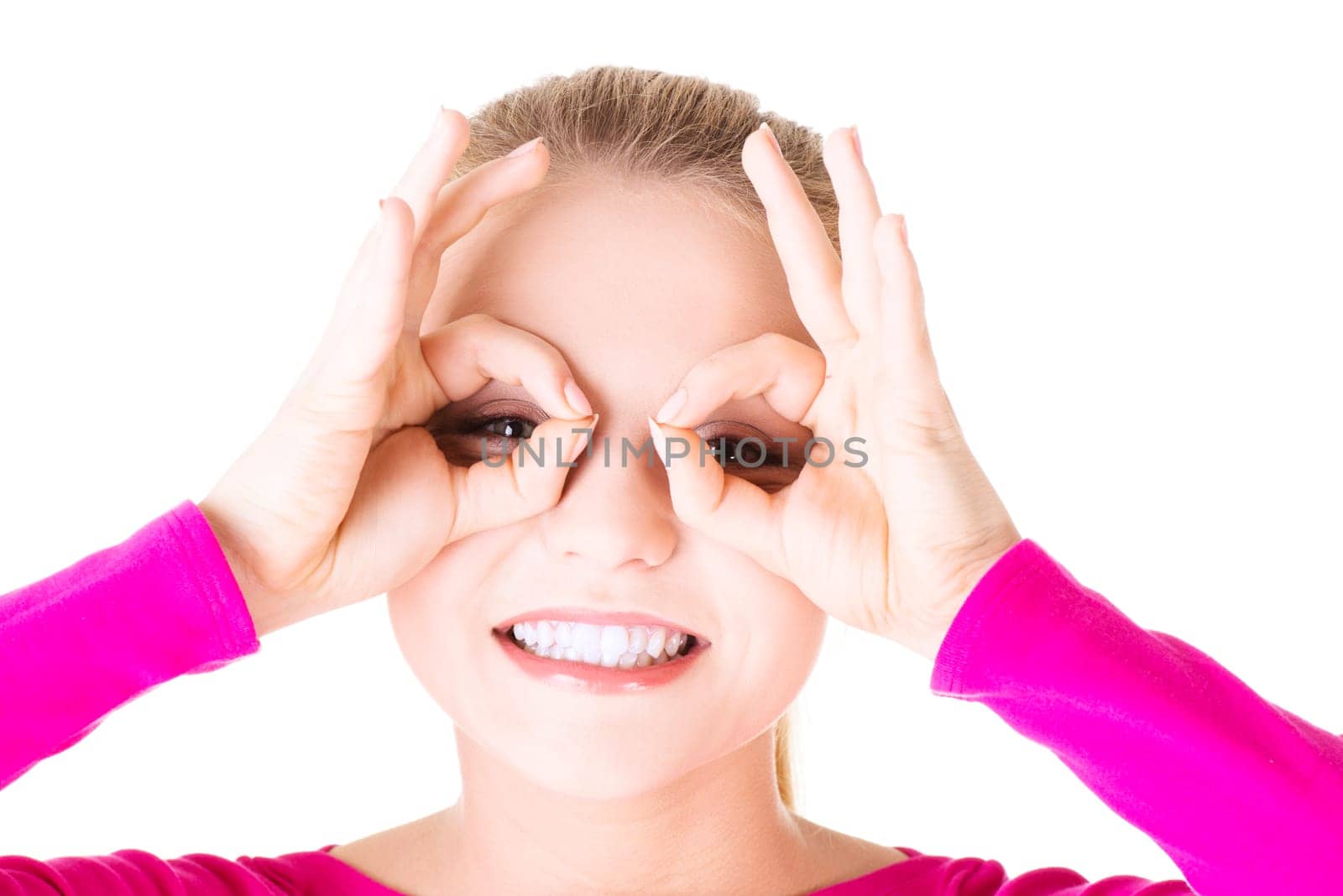 Young woman looking through imaginary binocular, isolated on white.
