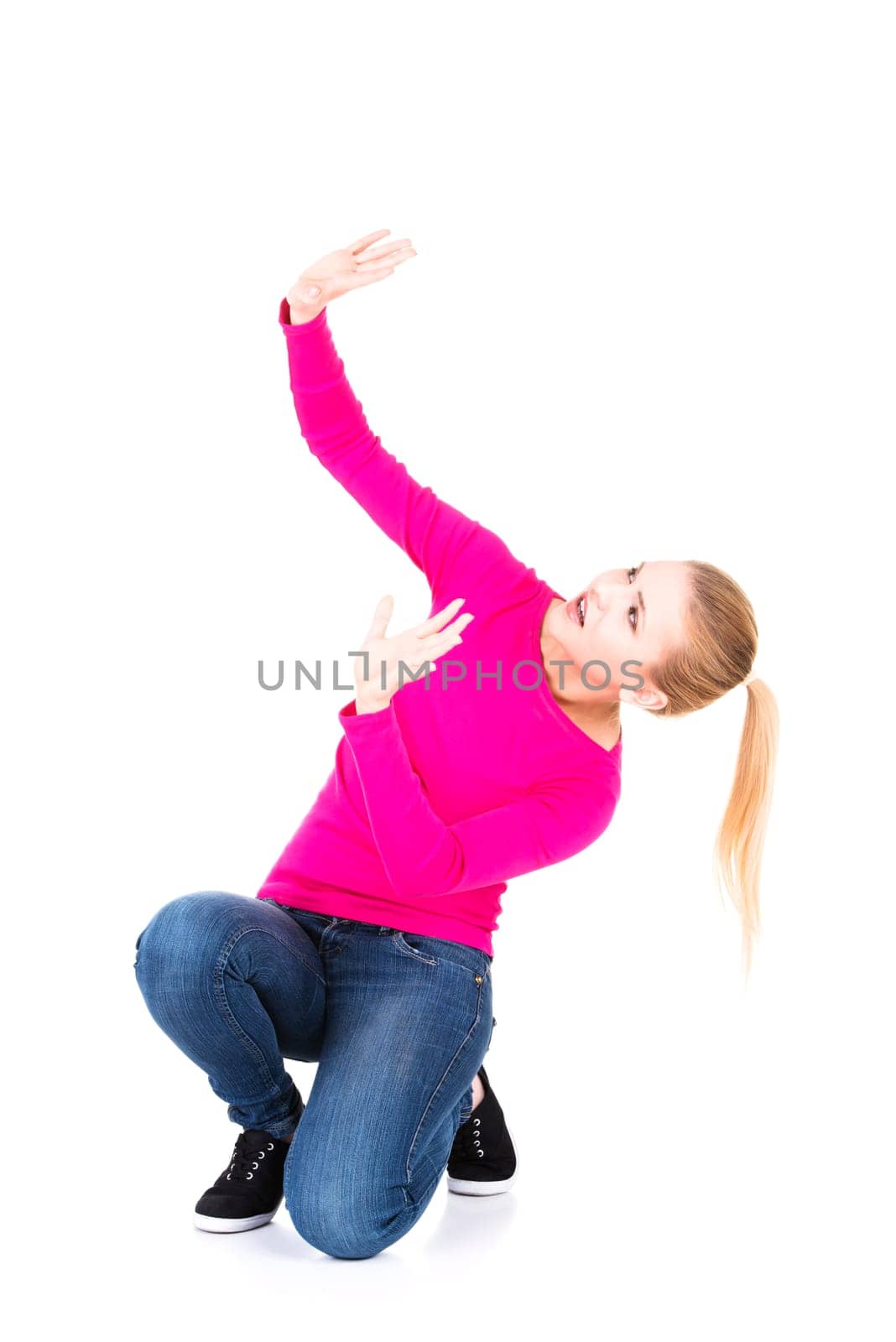 Scared young woman afraid of something above her, isolated on white