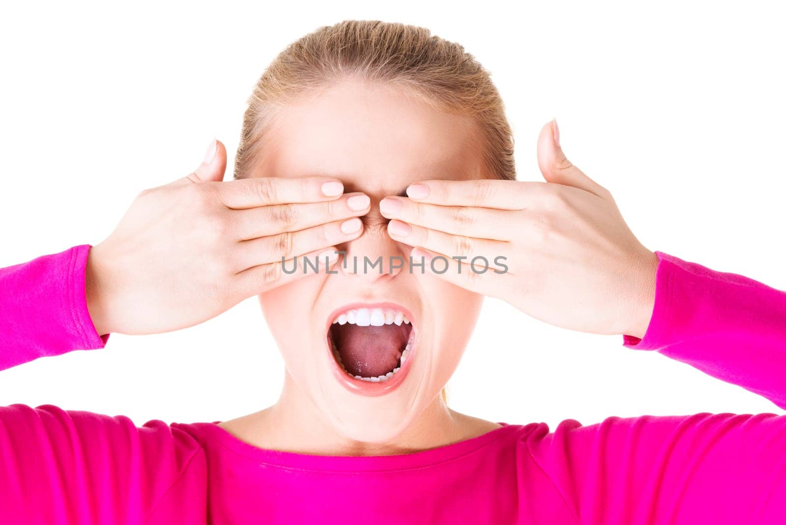 Young teen woman covering her face with hands, isolated on white