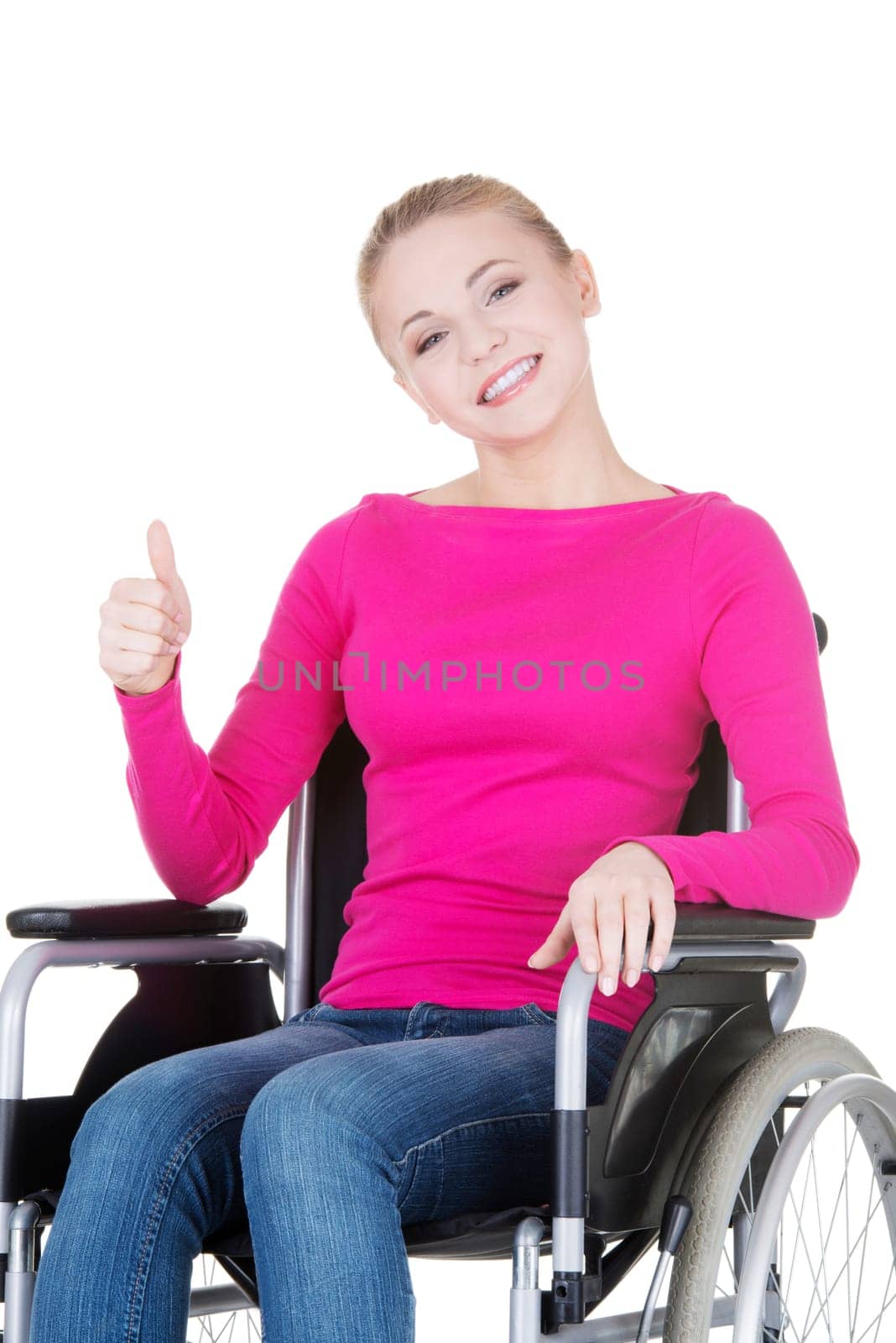 Attractive smiling disabled woman sitting in a wheel chair isolated on white