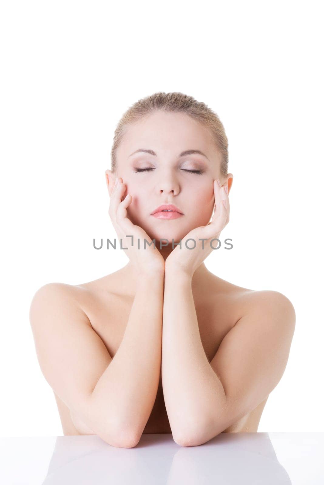 Young beautiful woman face with healthy clean skin. Isolated on white background.