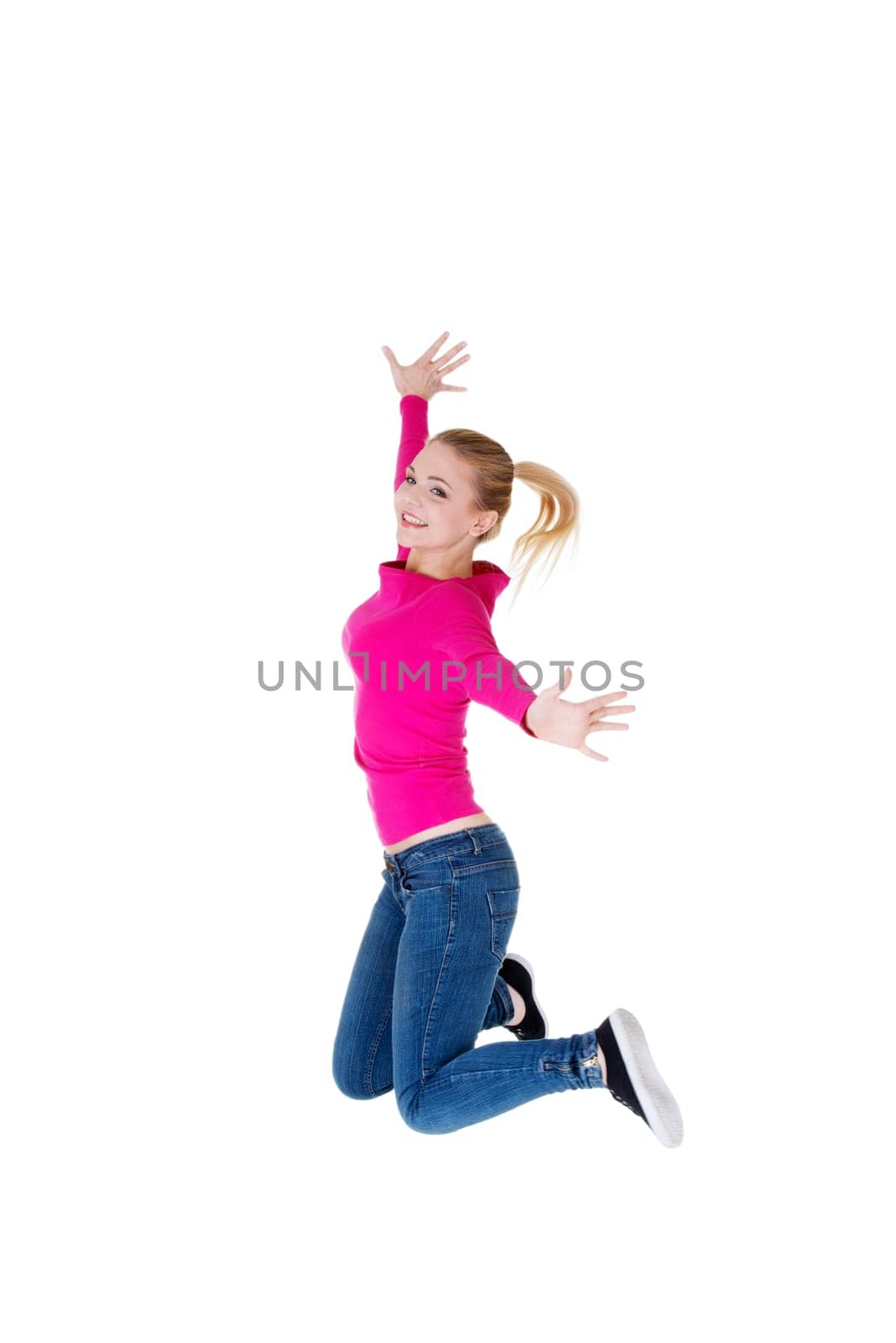 Young happy caucasian woman jumping in the air , isolated on white background