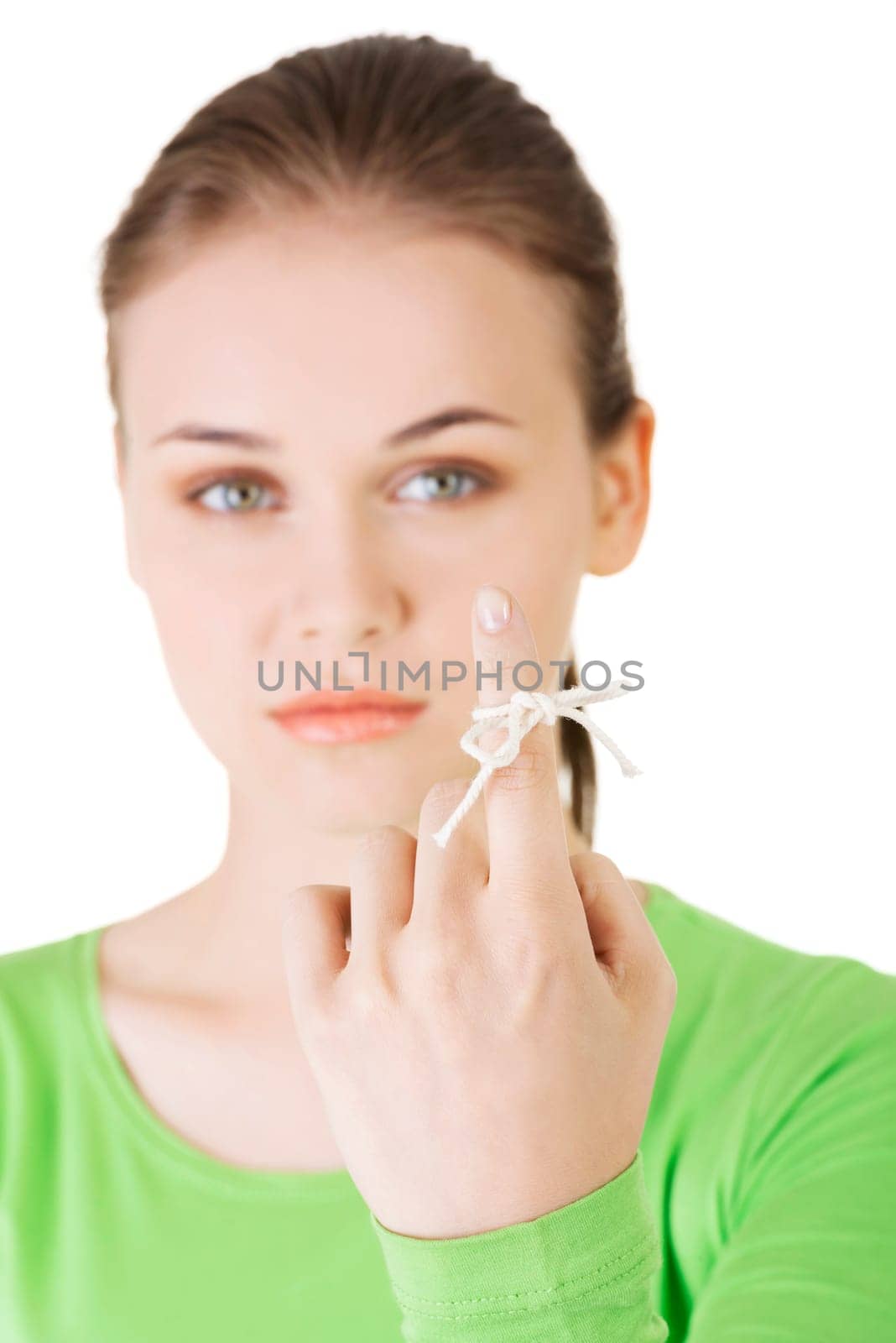Woman trying to remember what the piece of string round her finger was meant to remind her of, isolated on white background.