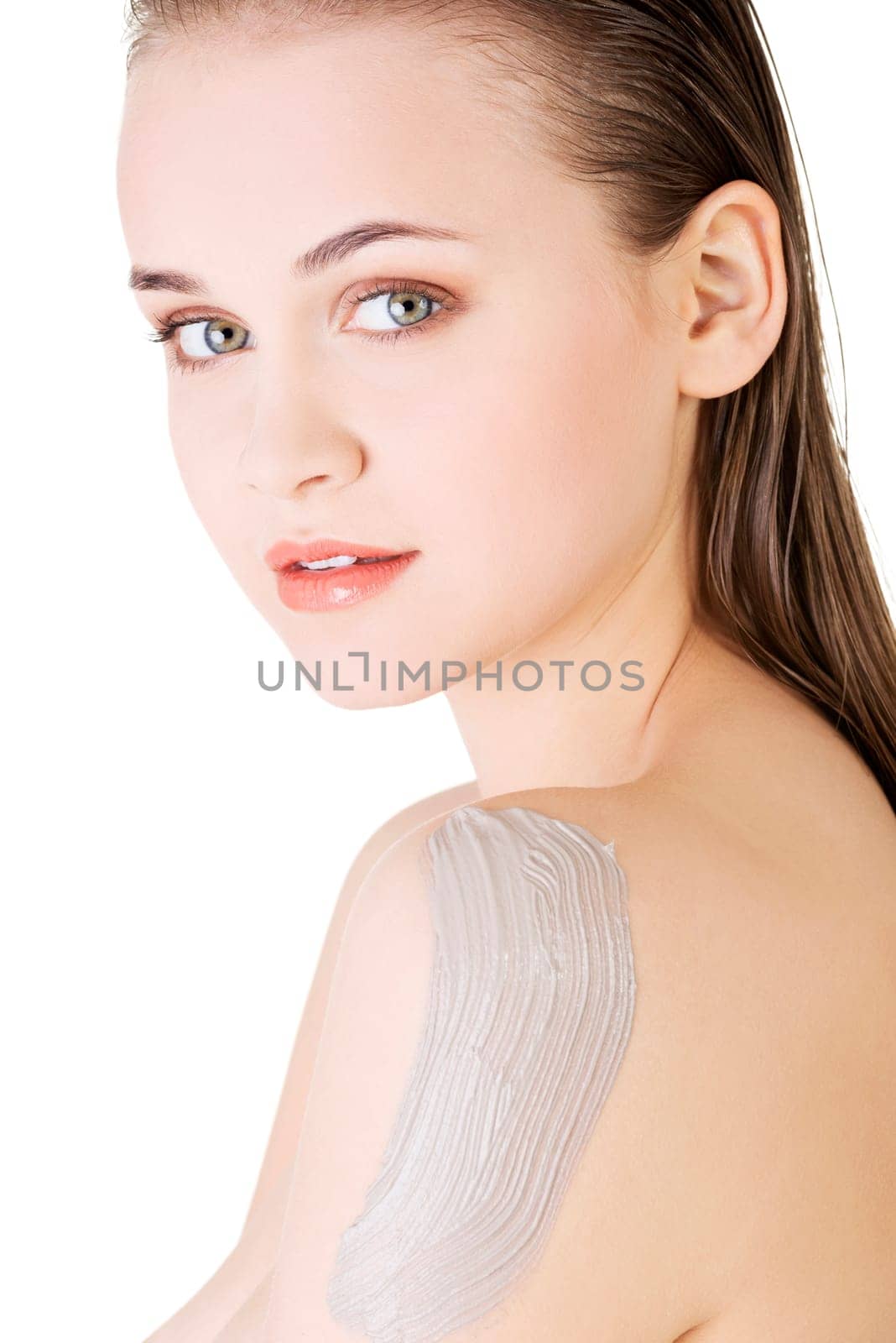 Beautiful face of spa woman with healthy clean skin and clay mask on arm. Isolated on white.