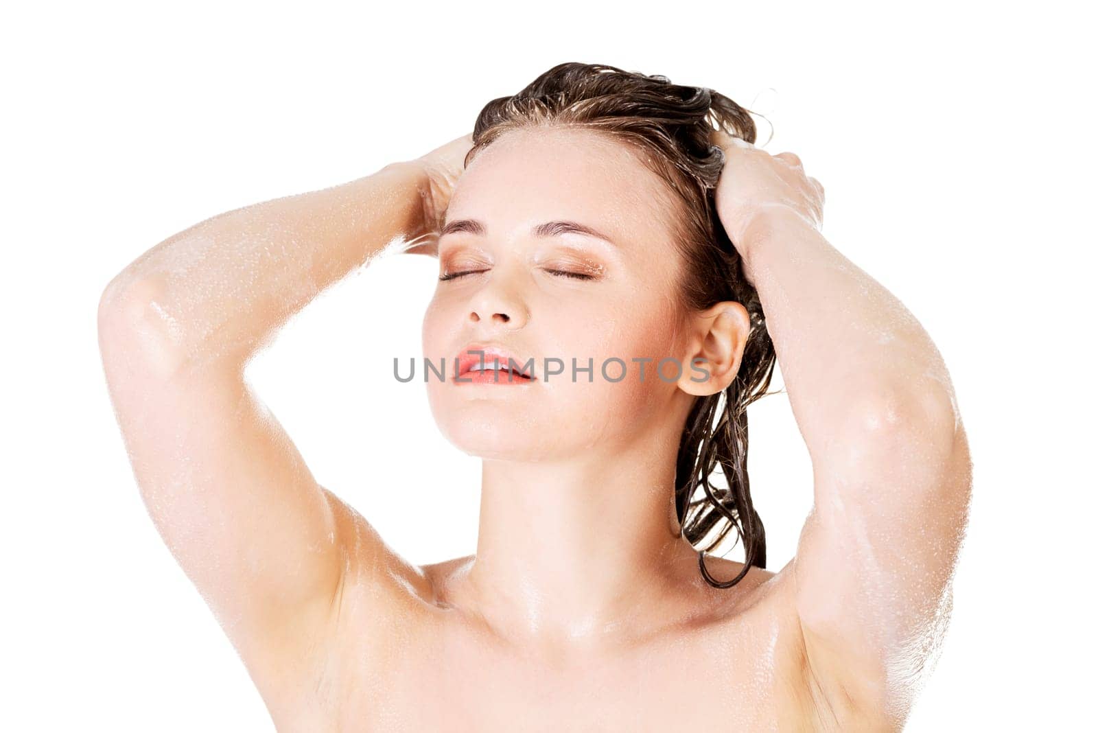 Young fit woman in shower washing her body