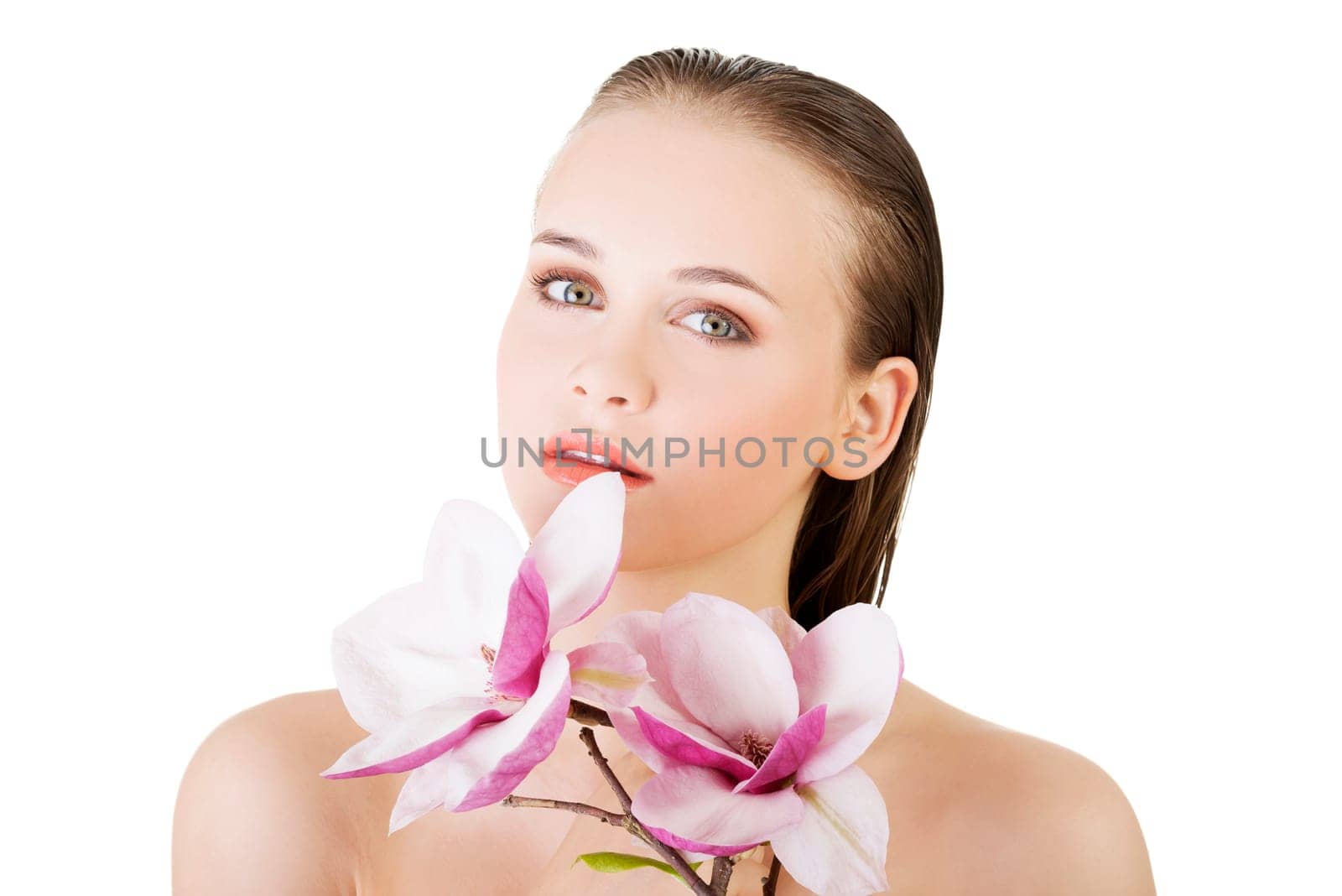 Beautiful face of spa woman with healthy clean skin and pink flowers. Isolated on white.