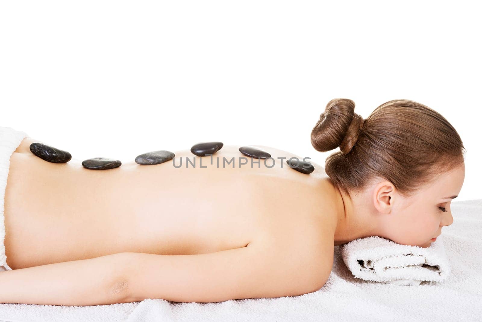 Beauty woman relaxing in spa. Stone massage. Isolateed.