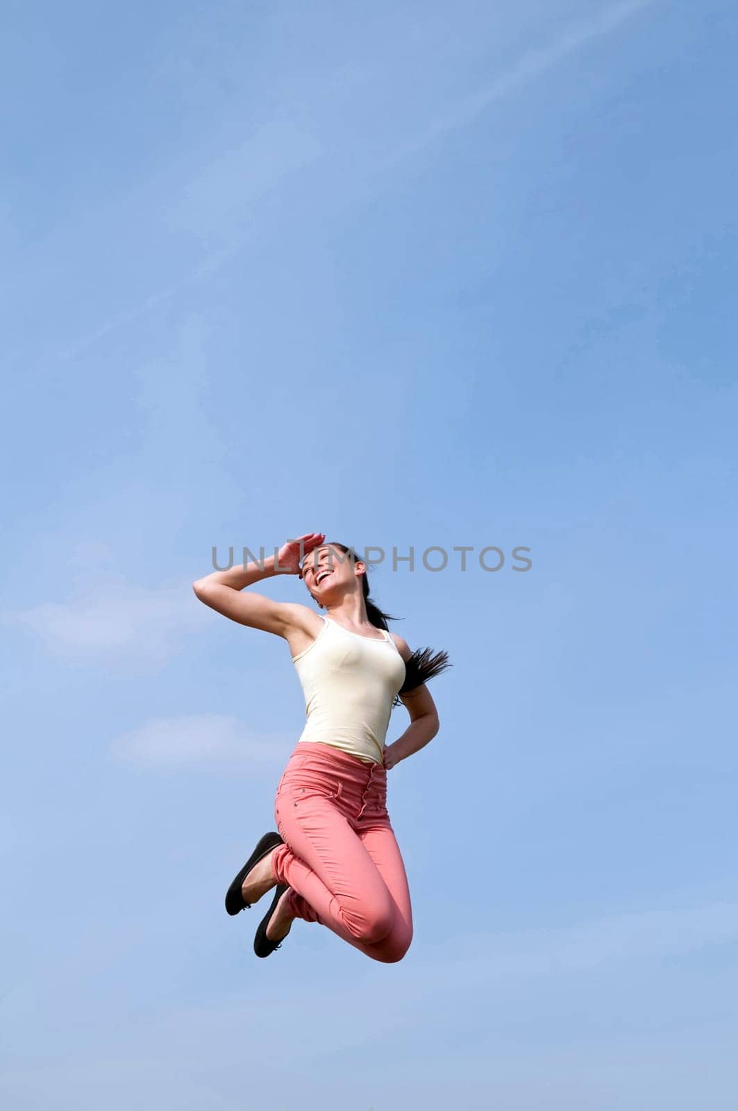 young woman makes leap of joy