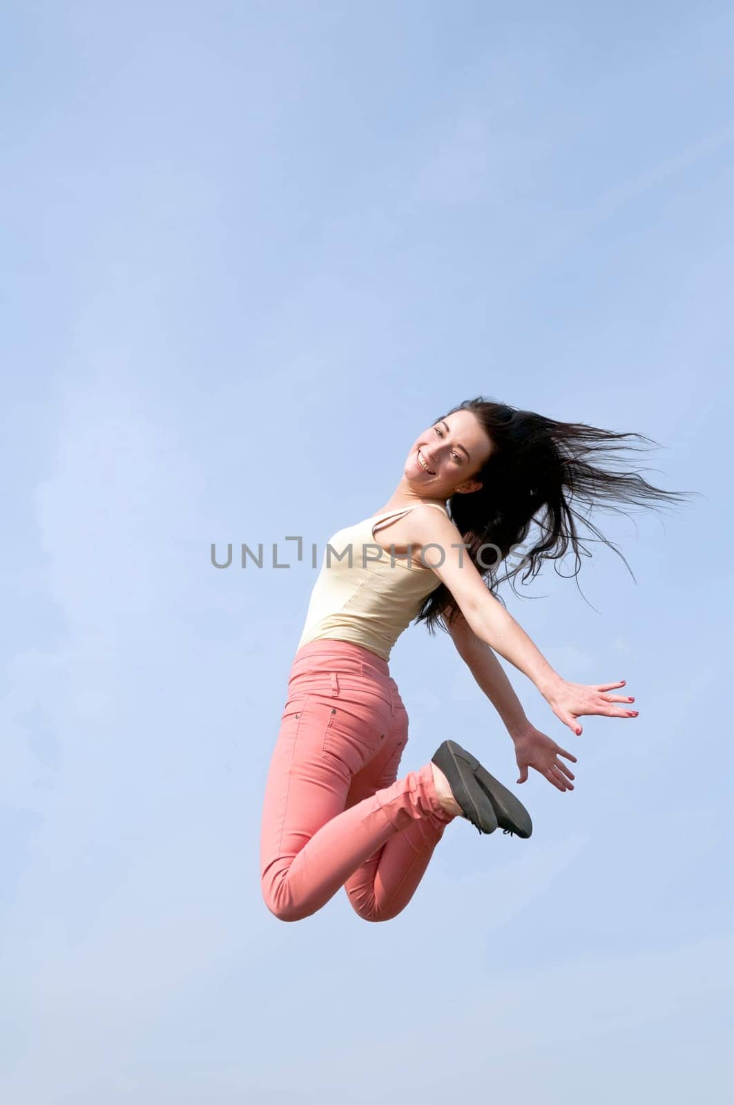 laughing woman makes leap of joy