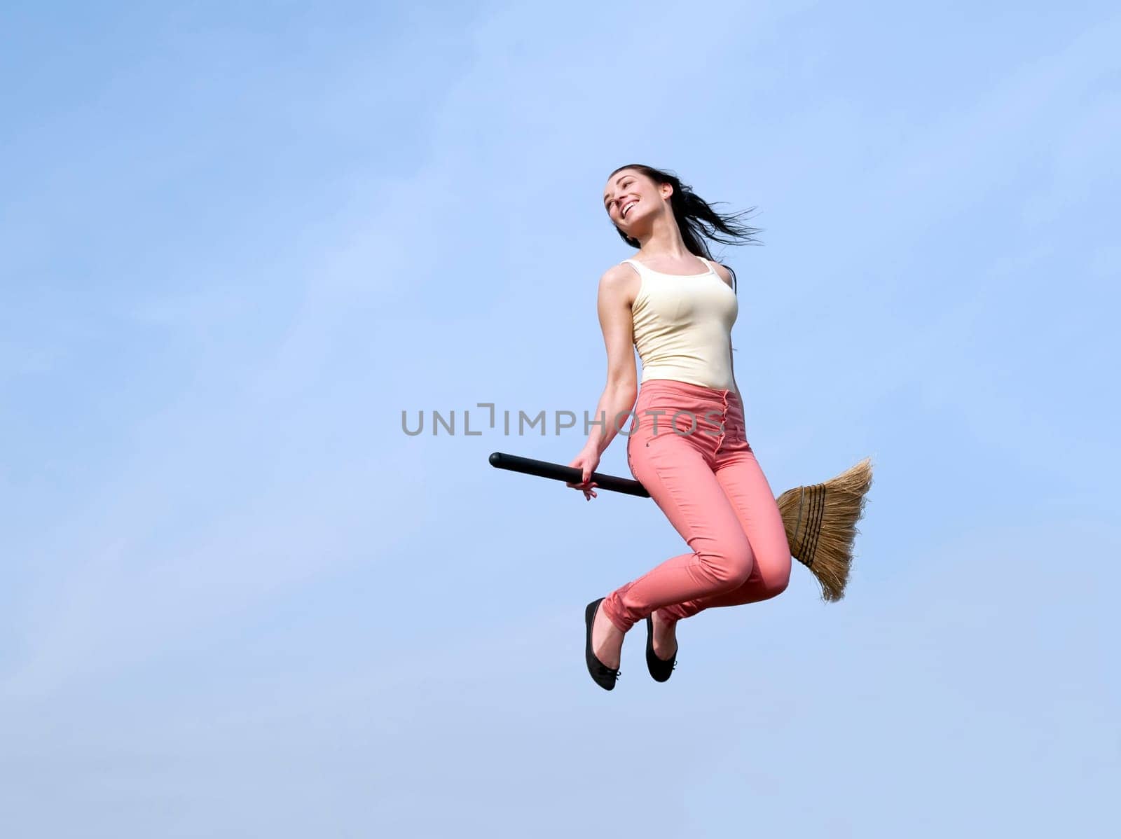 young woman flies with broom