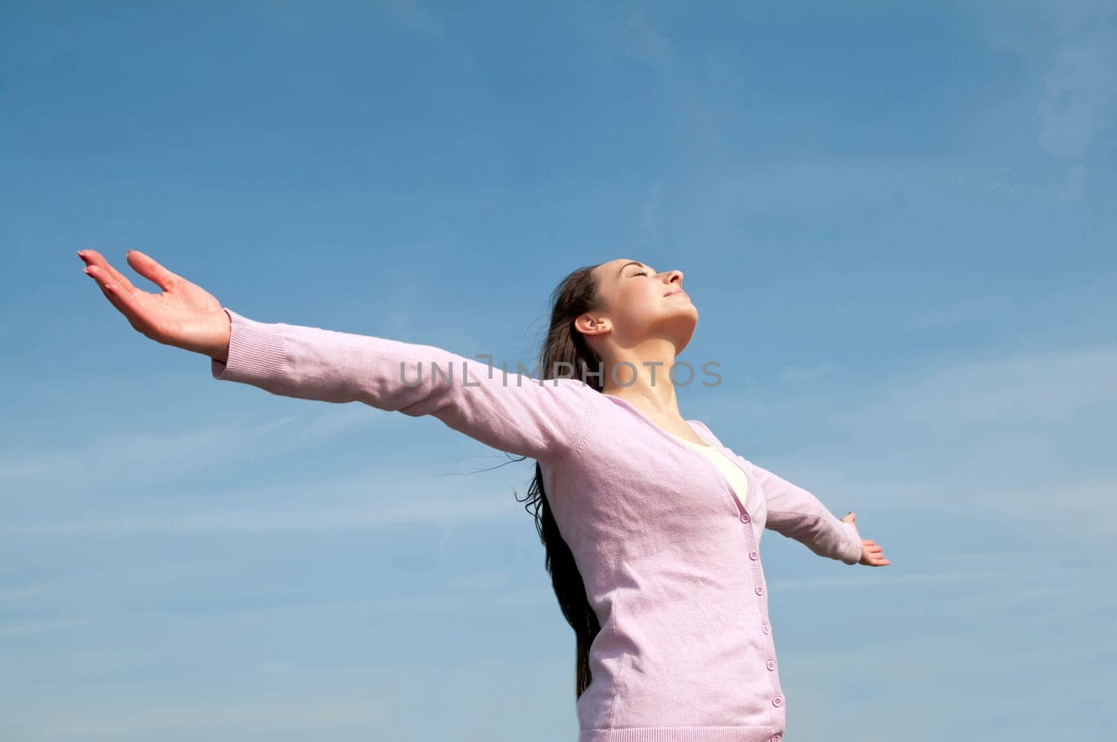 happy woman with outstretched arms feels free