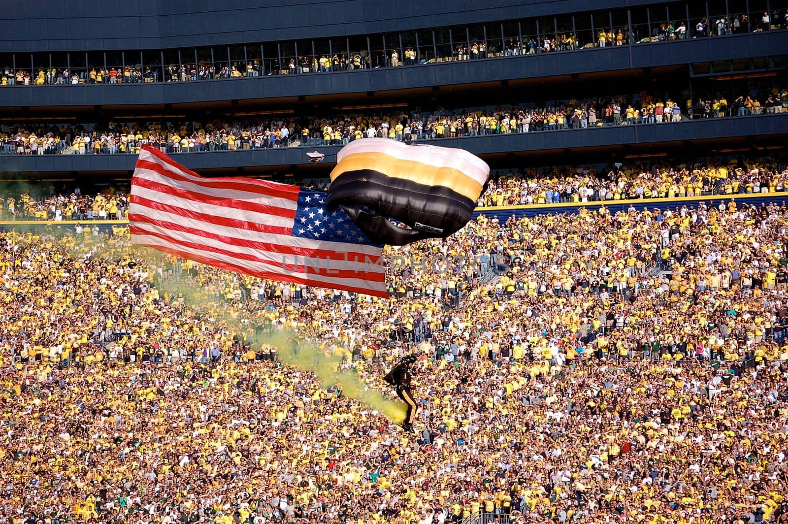 ANN ARBOR, MI - OCTOBER 09: 101st Airborne Division Parachute Demonstration Team member parachutes past the crowd at Michigan Stadium before the Michigan vs. Michigan State football game October 9, 2010.