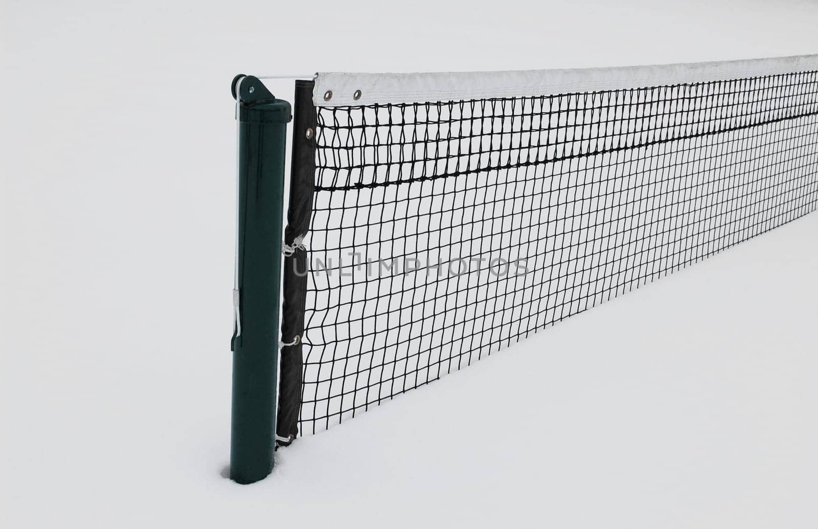 Tennis court half buried in snow in winter