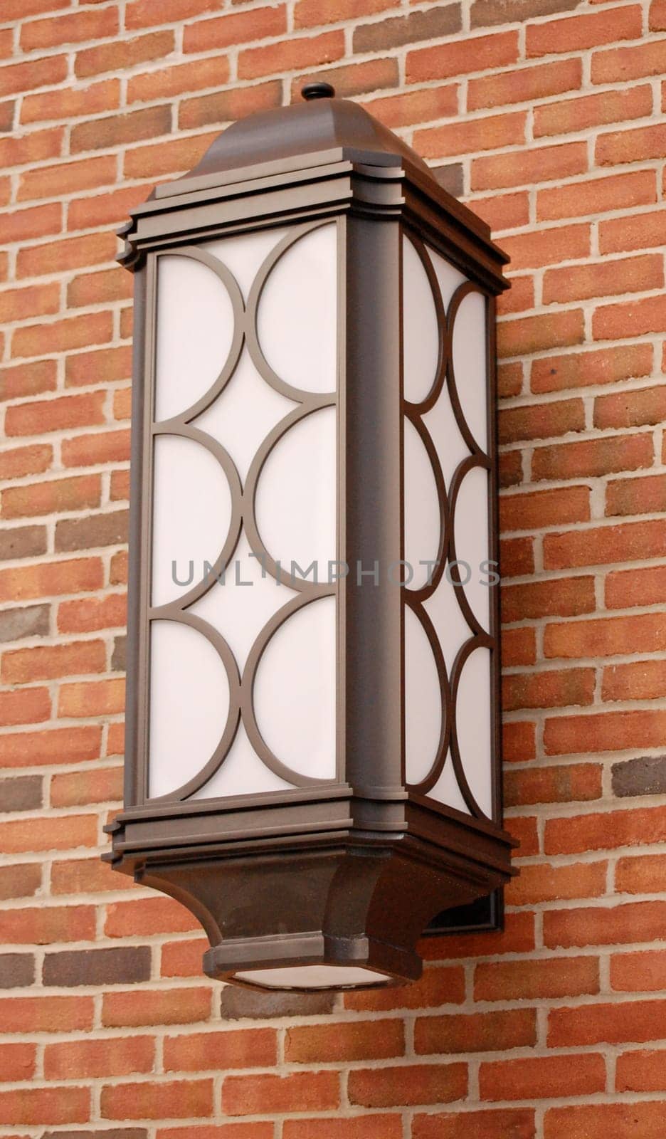Metal sconce on brick background, outdoors wall