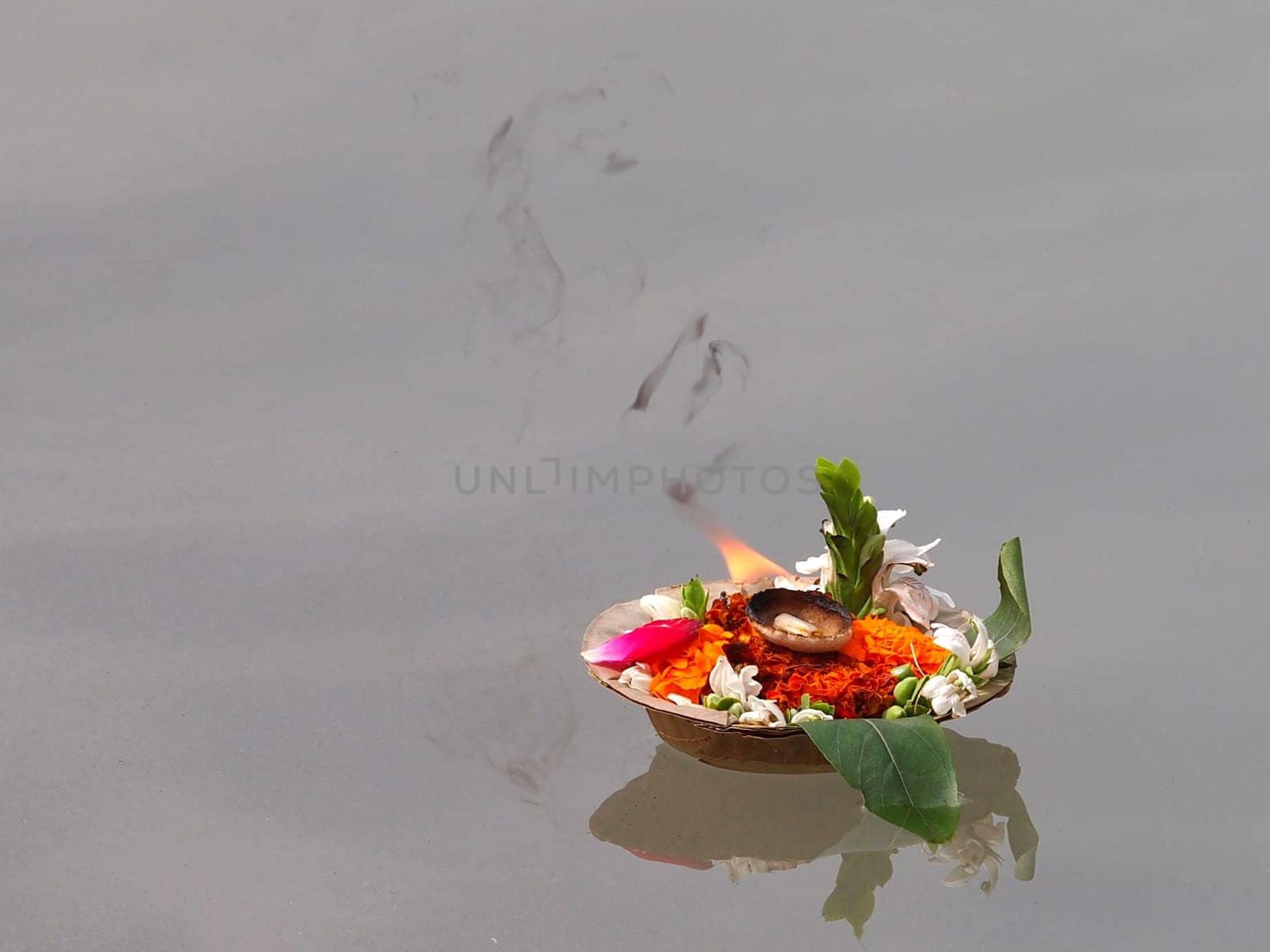 flowers and candles on the ganges river in the india