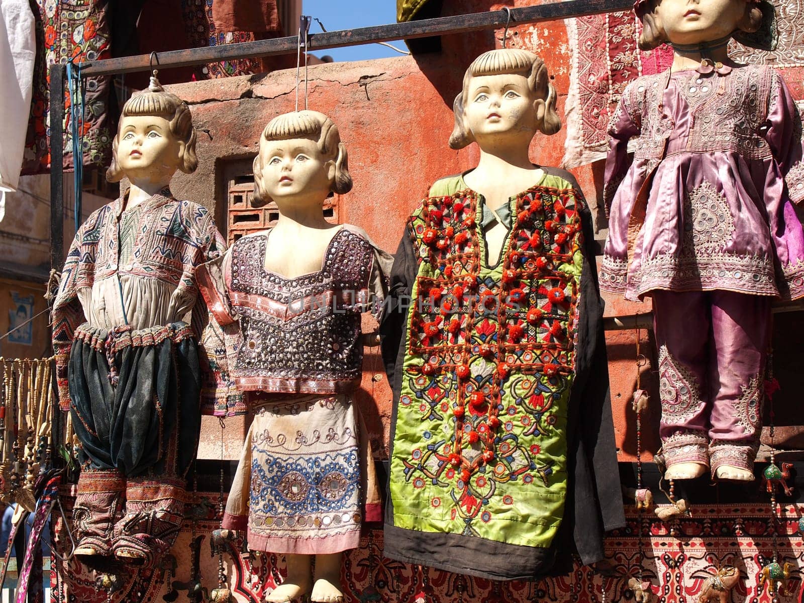 old dolls dressed im many colors