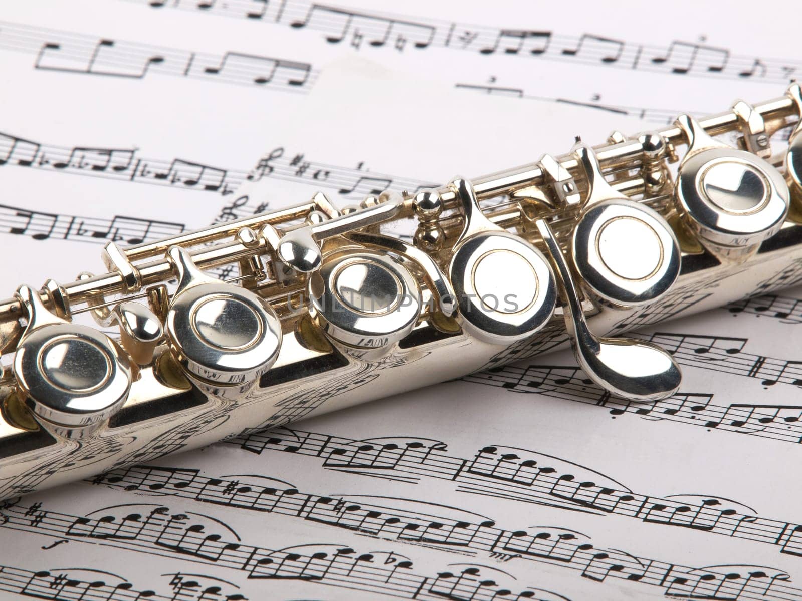 used flute rests across an open musical score. Only one line of music is in focus.