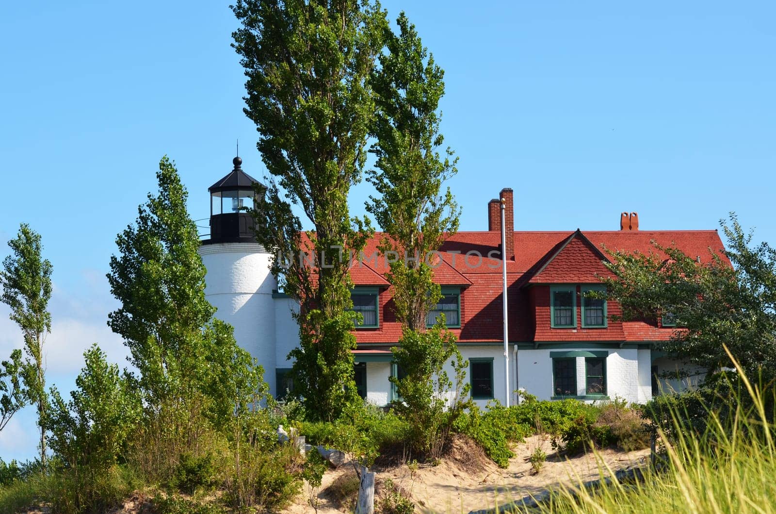 Pt. Betsie lighthouse, lake Michigan, with trees and sand dunes