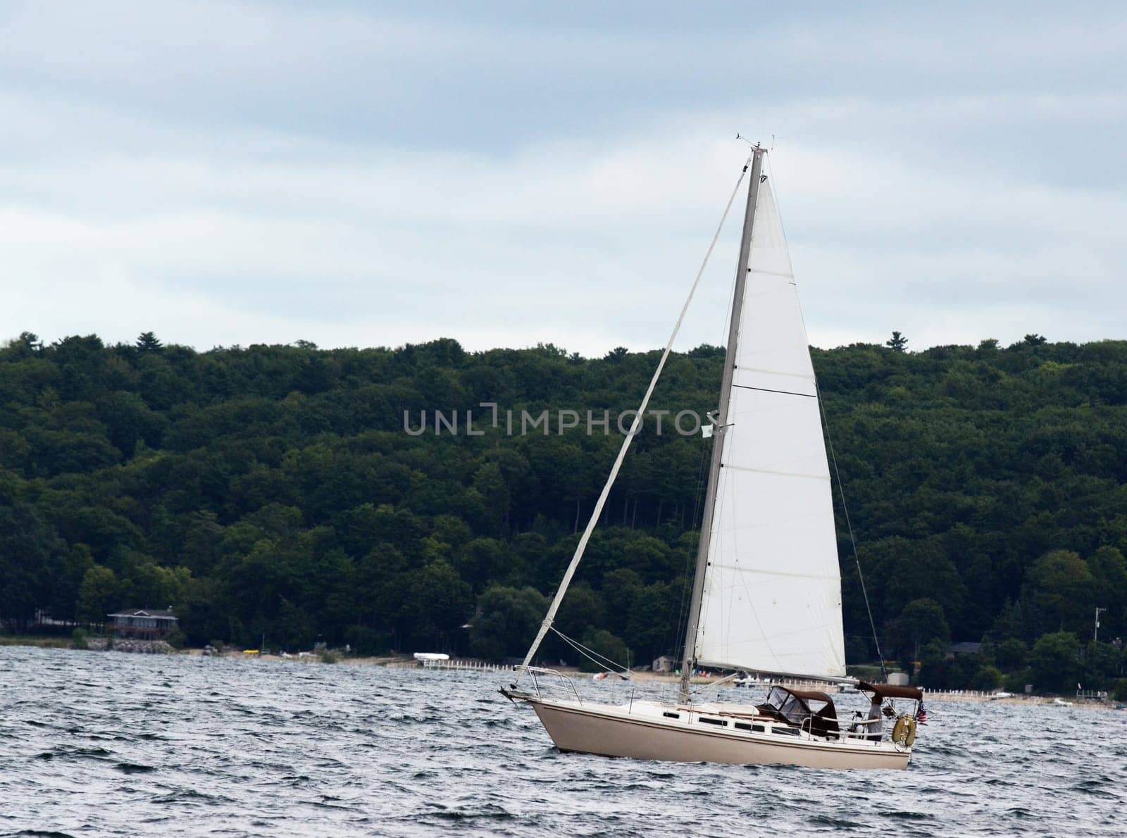Sailboat in rough lake waters on a cloudy day