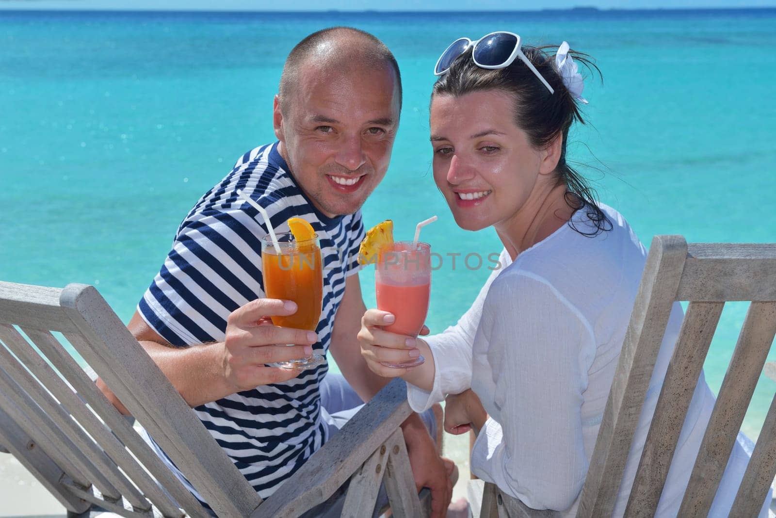 happy young couple relax and take fresh drink at summer vacation