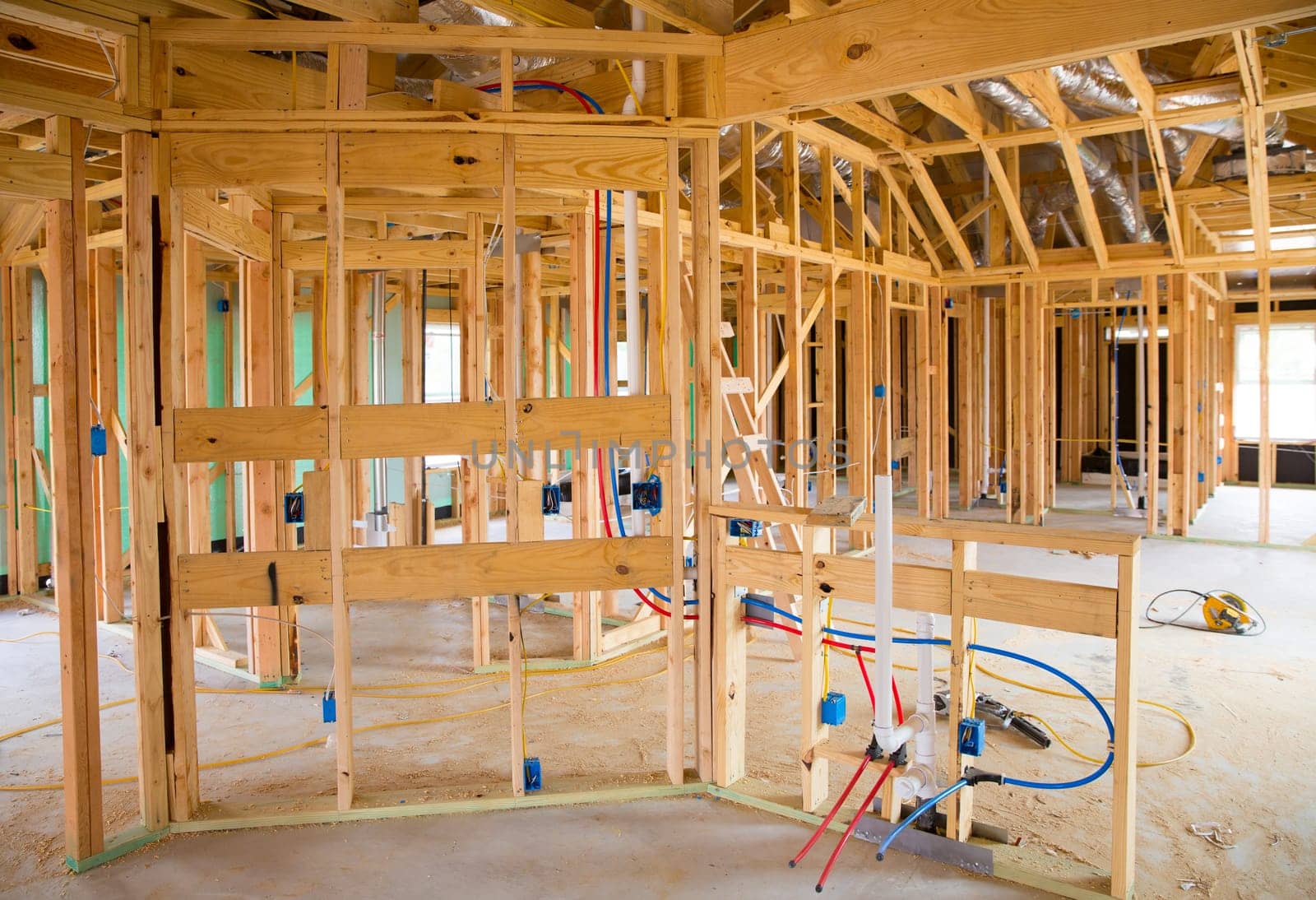 American residential wooden house contruction with structure and pipes