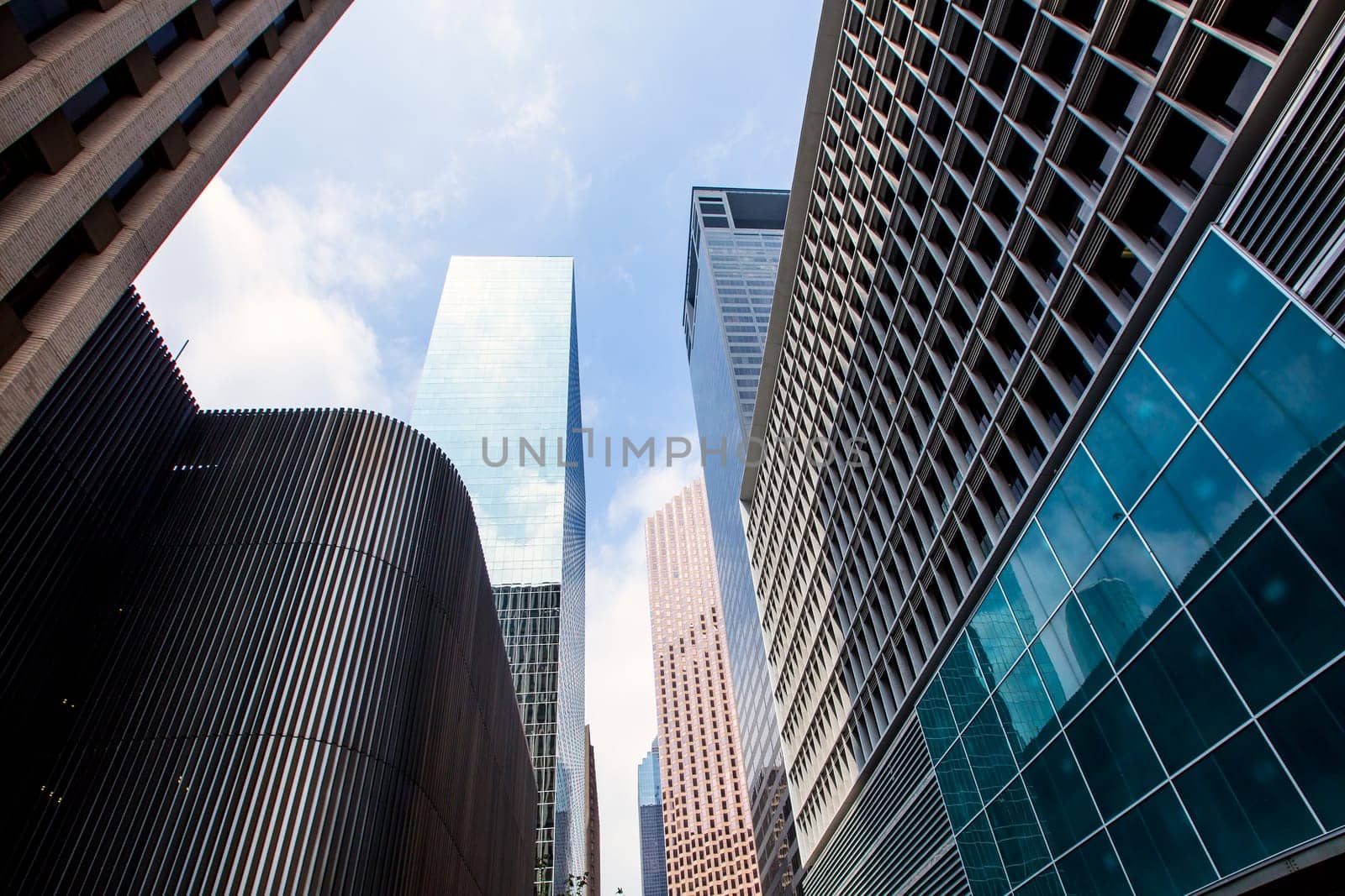 Houston downtown skyscrapers disctict with mirror blue sky reflection