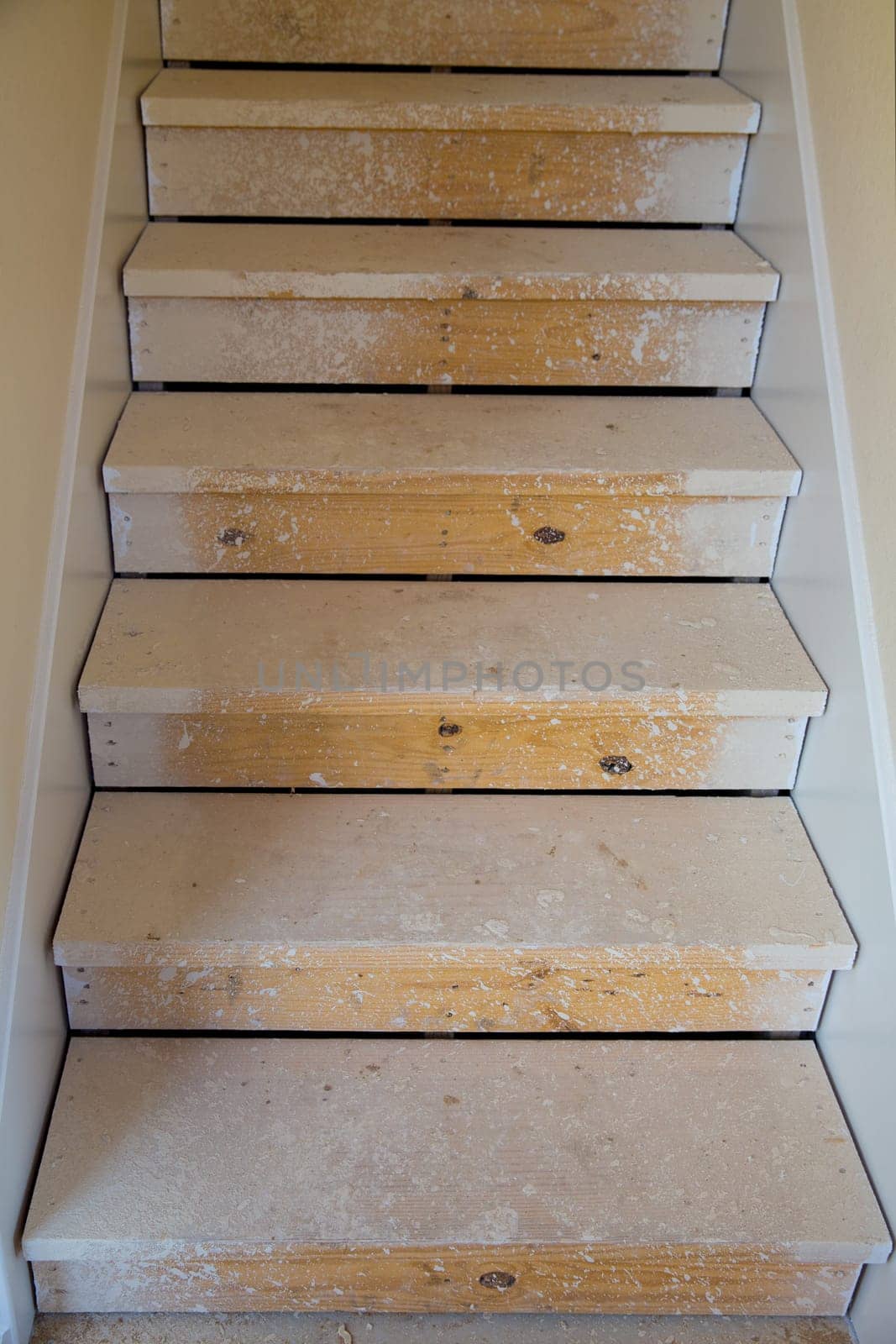 Wooden stairs in new house construction before painting process