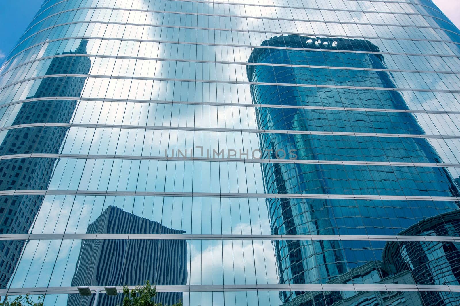 Houston downtown skyscrapers disctict with mirror blue sky reflection