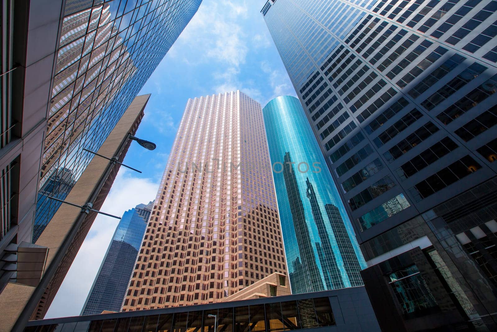 Houston downtown skyscrapers disctict with mirror blue sky reflection