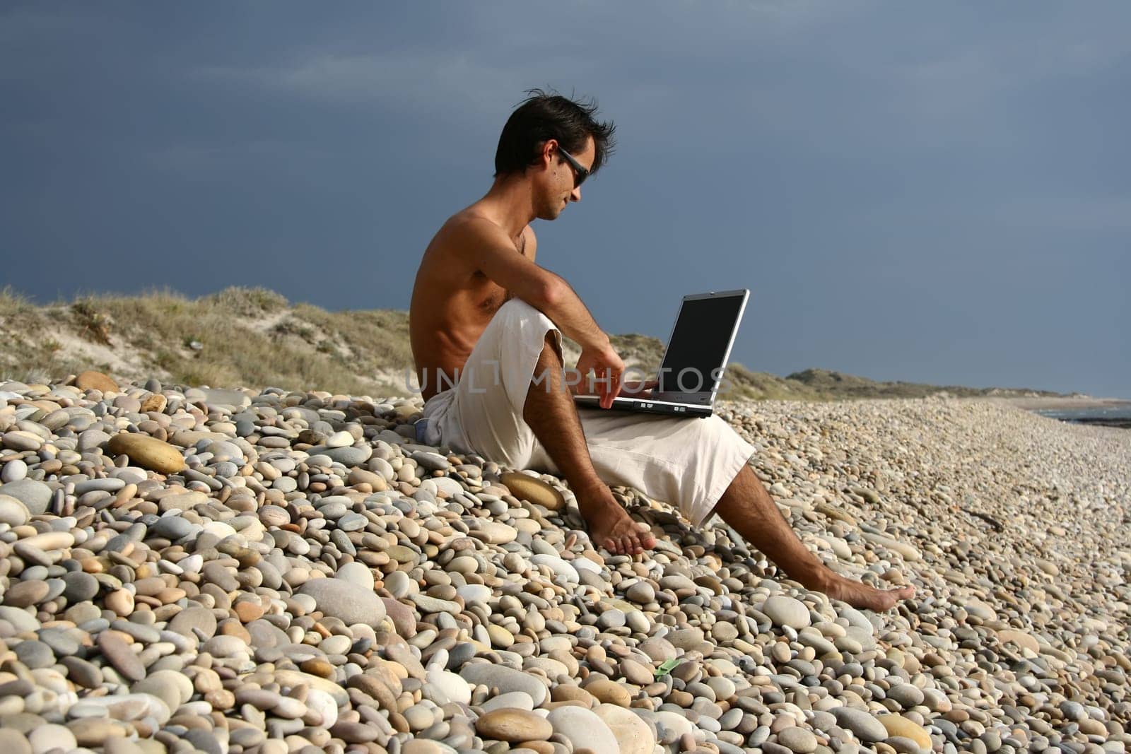 Surfer working on his laptop