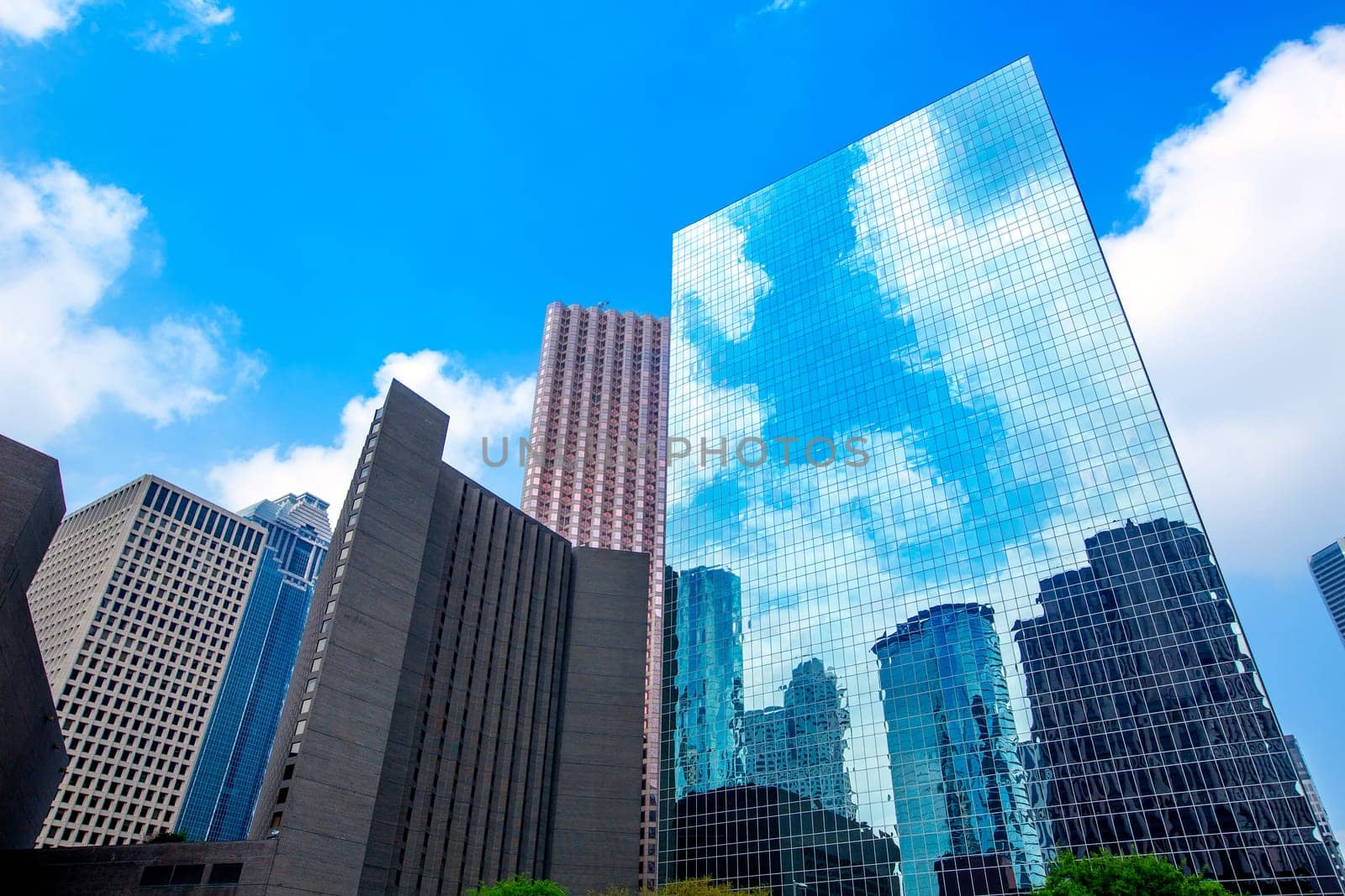 Houston downtown skyscrapers disctict with mirror blue sky reflection