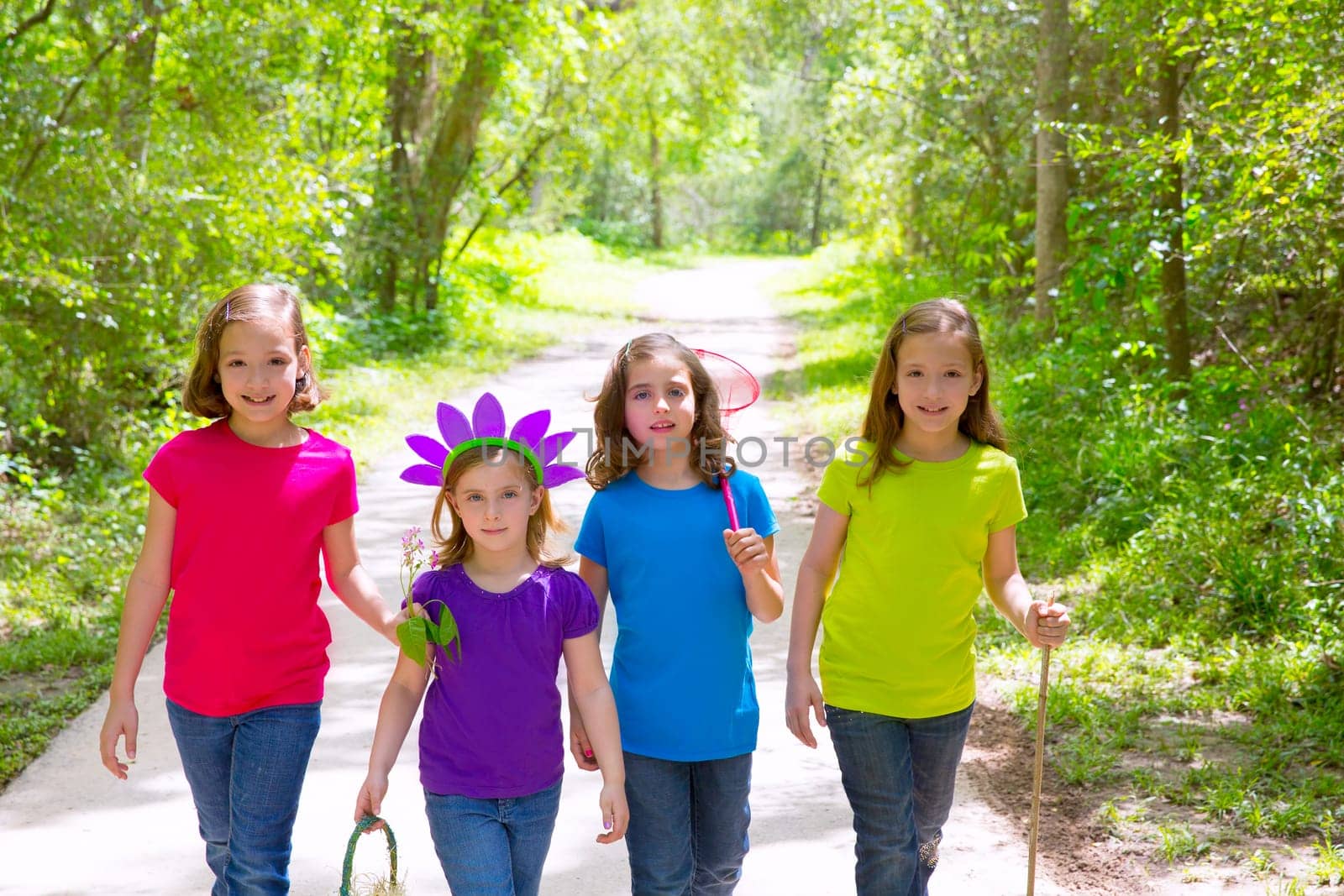 Friends and sister girls walking outdoor in forest track excursion